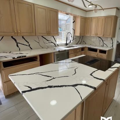 There is a large island in the middle of the kitchen.