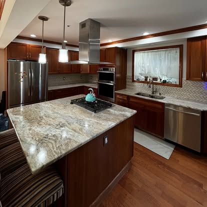 A kitchen with stainless steel appliances and granite counter tops
