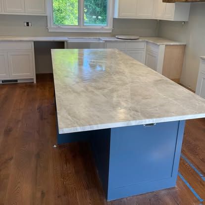 There is a large island in the middle of the kitchen.