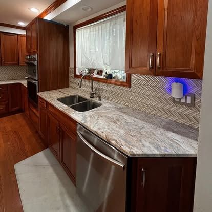 A kitchen with two sinks and a stainless steel dishwasher.
