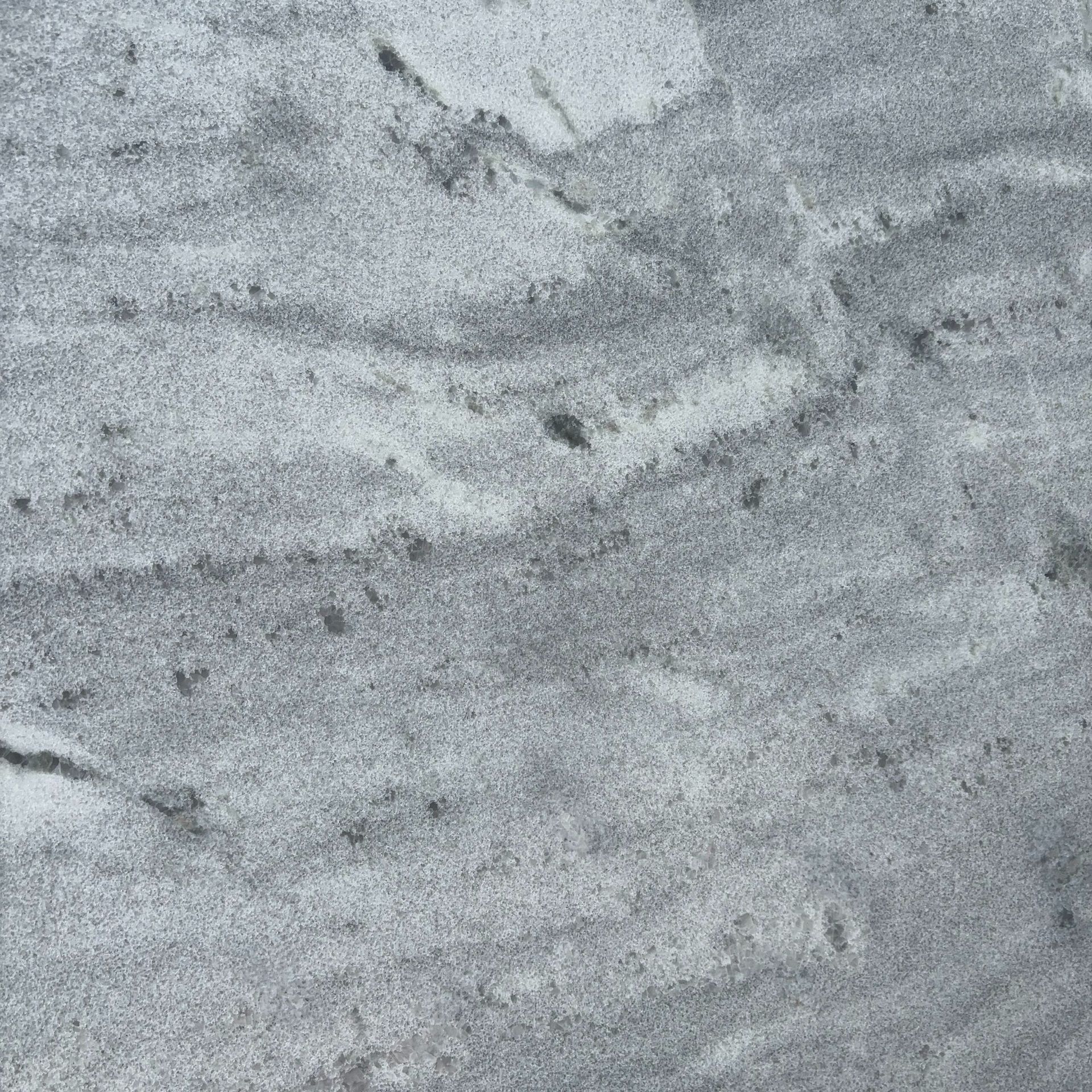 A close up of a gray granite counter top.