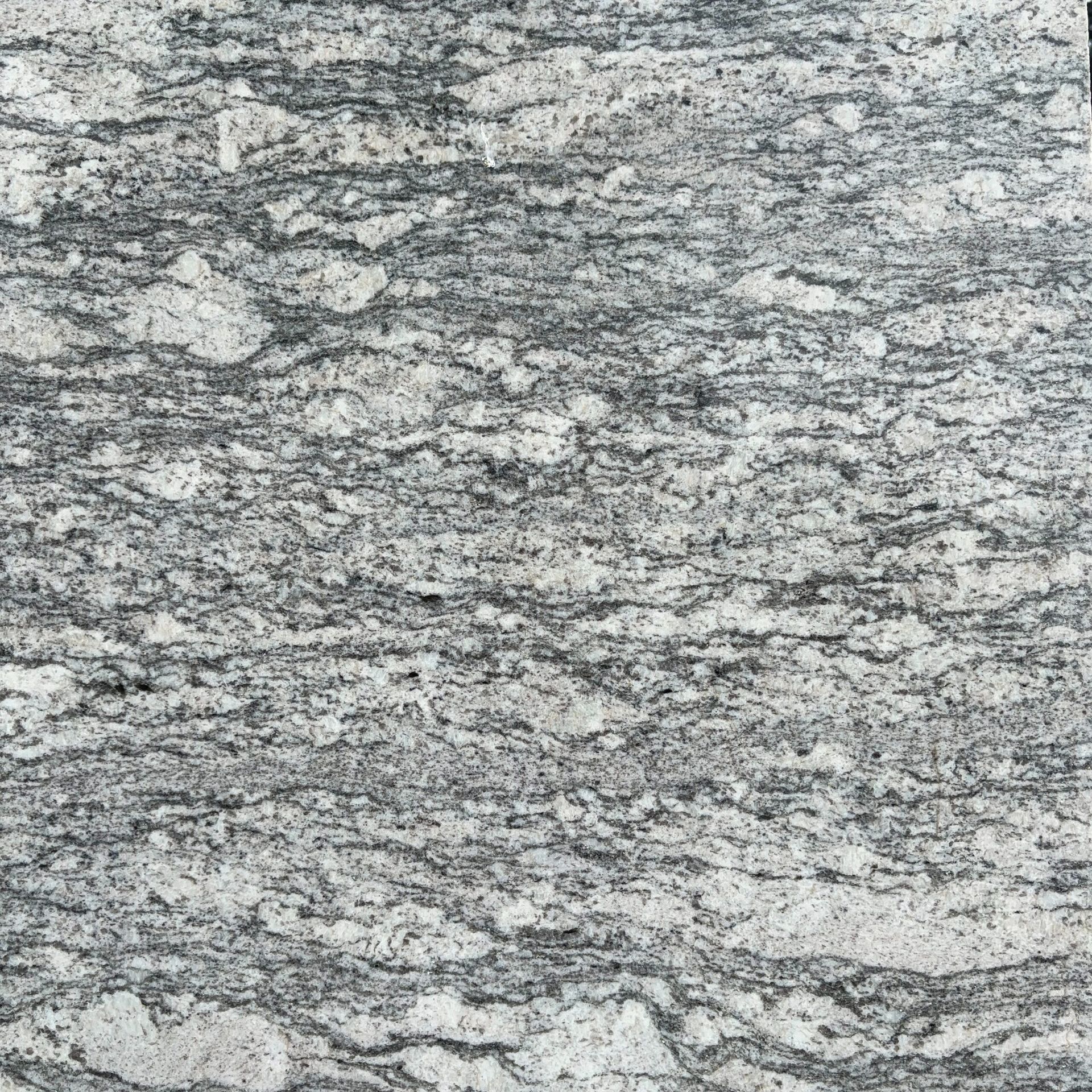 A close up of a gray and white granite counter top.