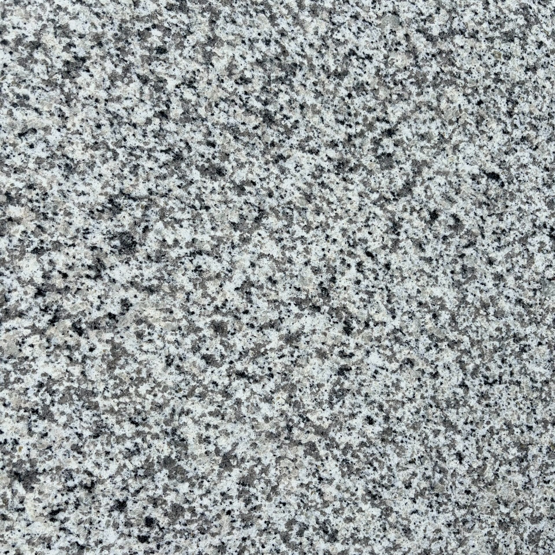 A close up of a gray granite counter top.