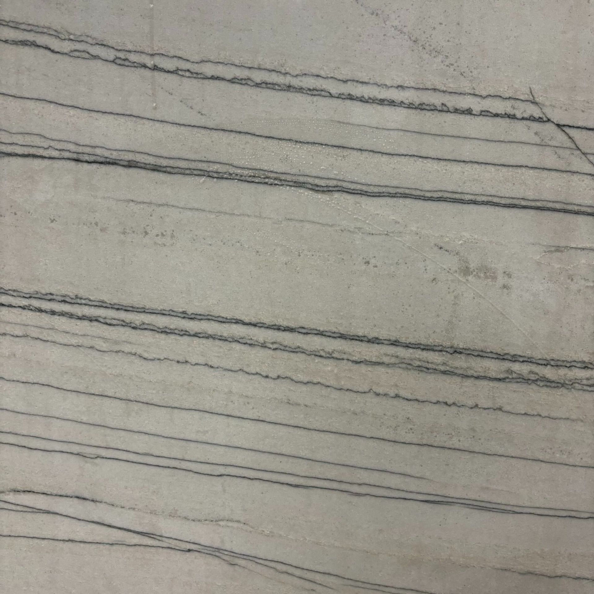 A close up of a white marble with black stripes