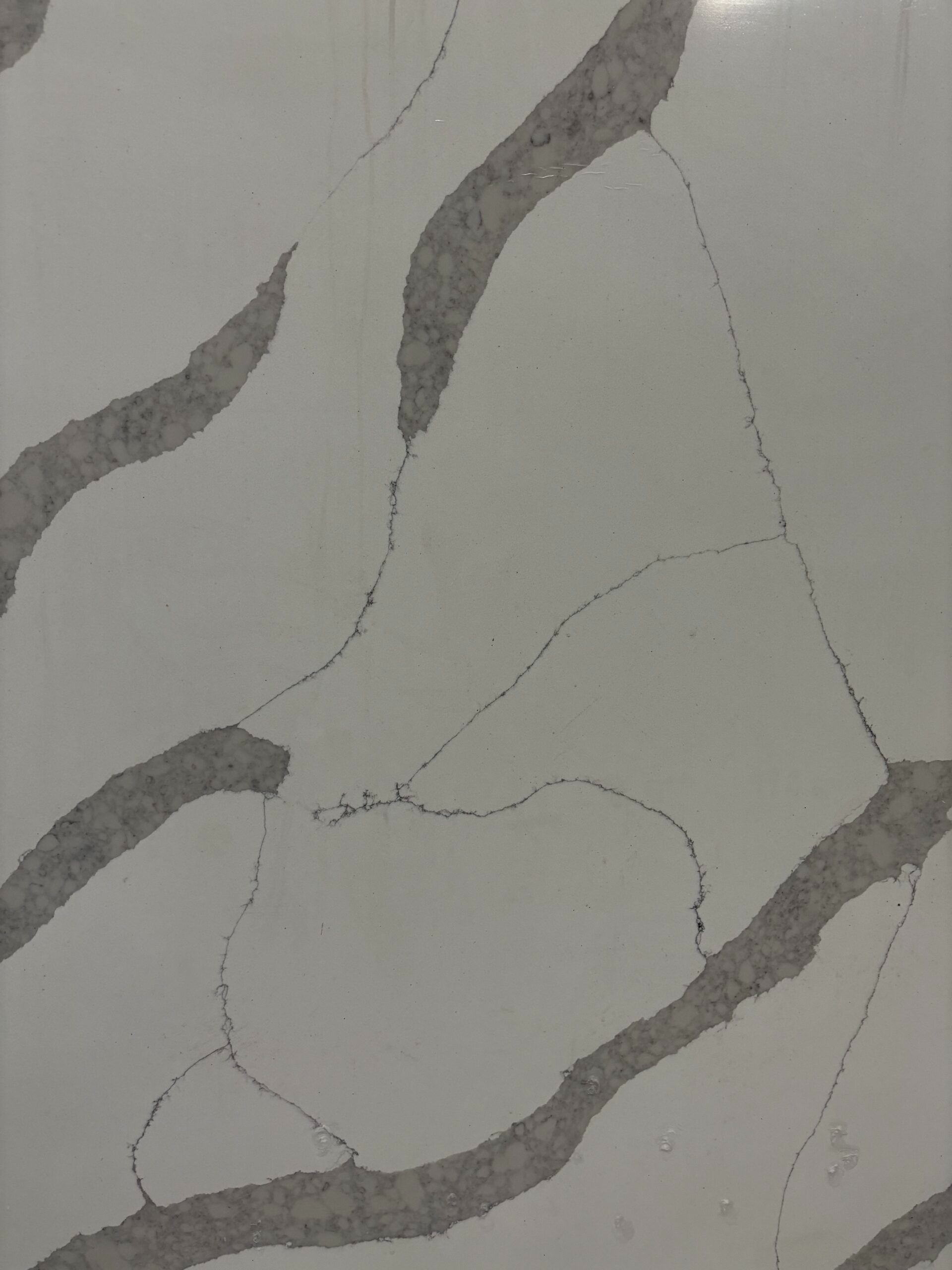 A close up of a white and gray marble counter top.