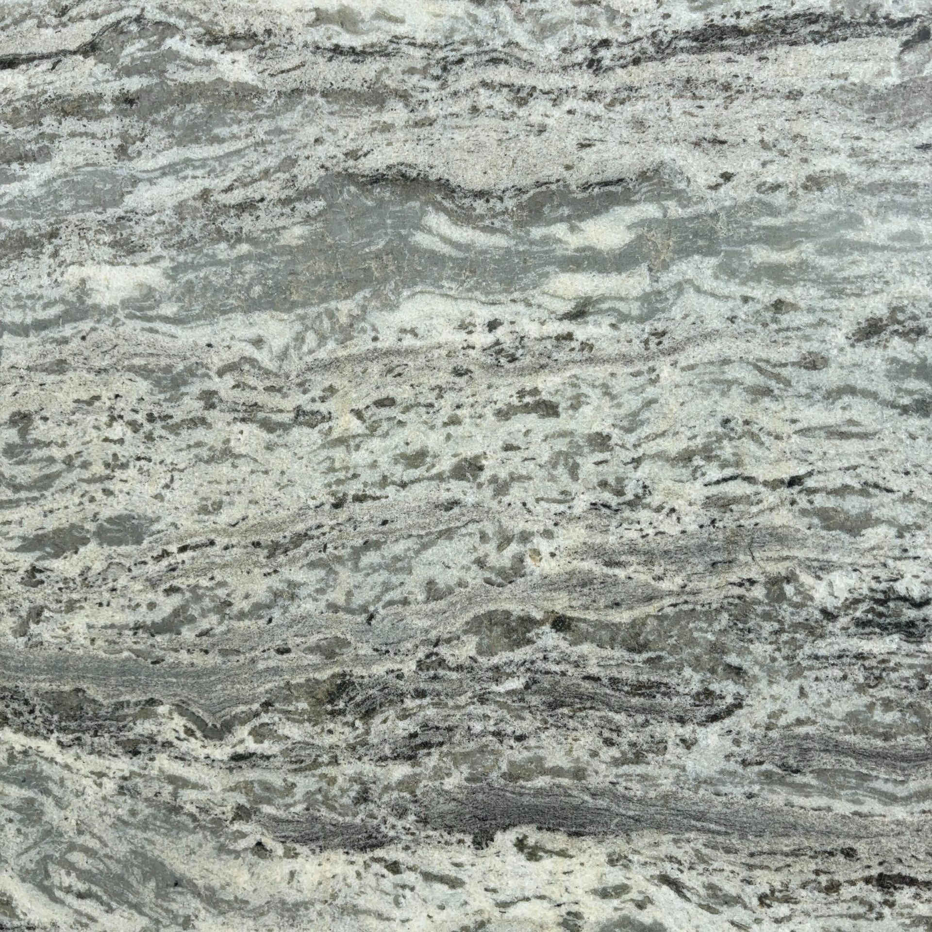 A close up of a gray and white granite counter top