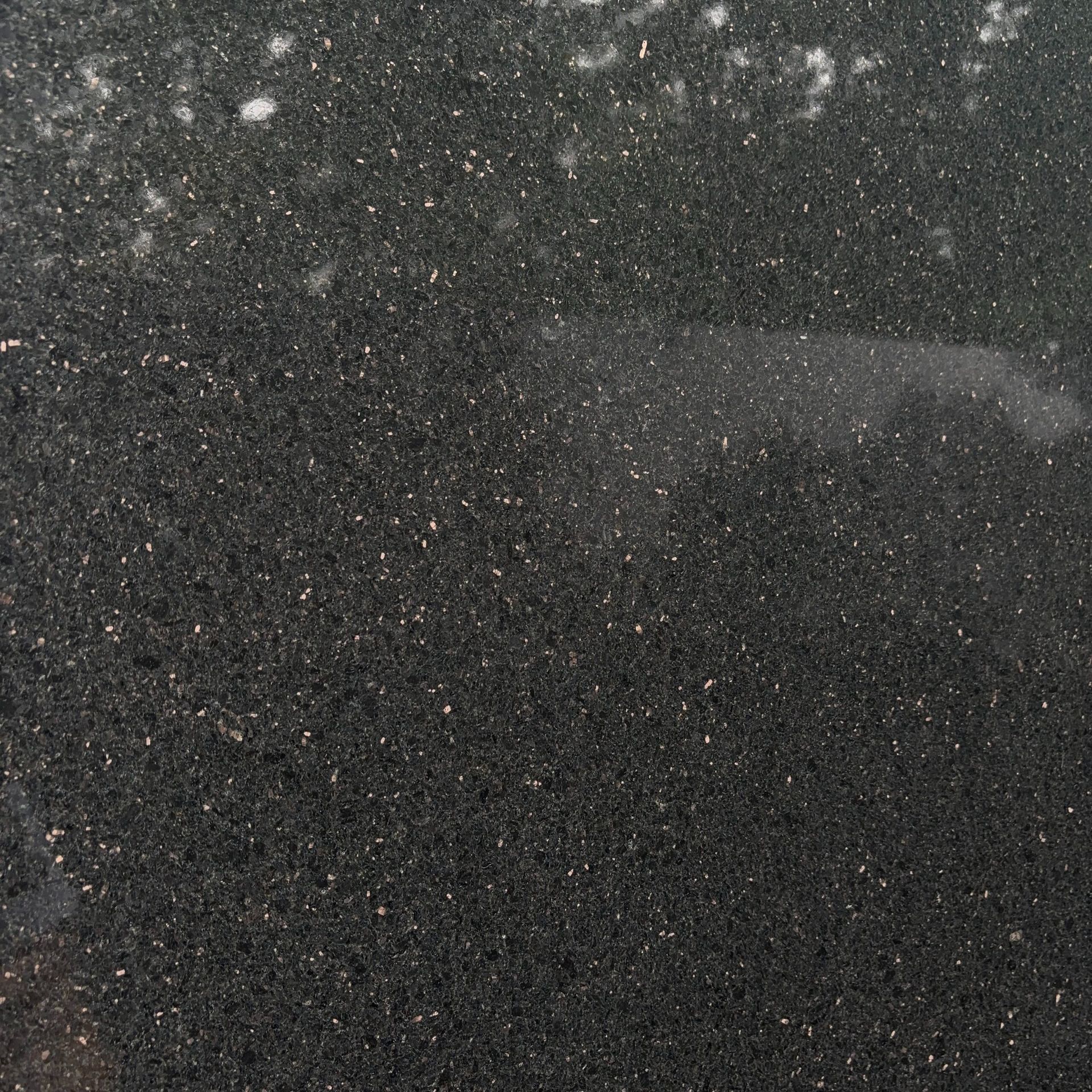 A close up of a black surface with white spots