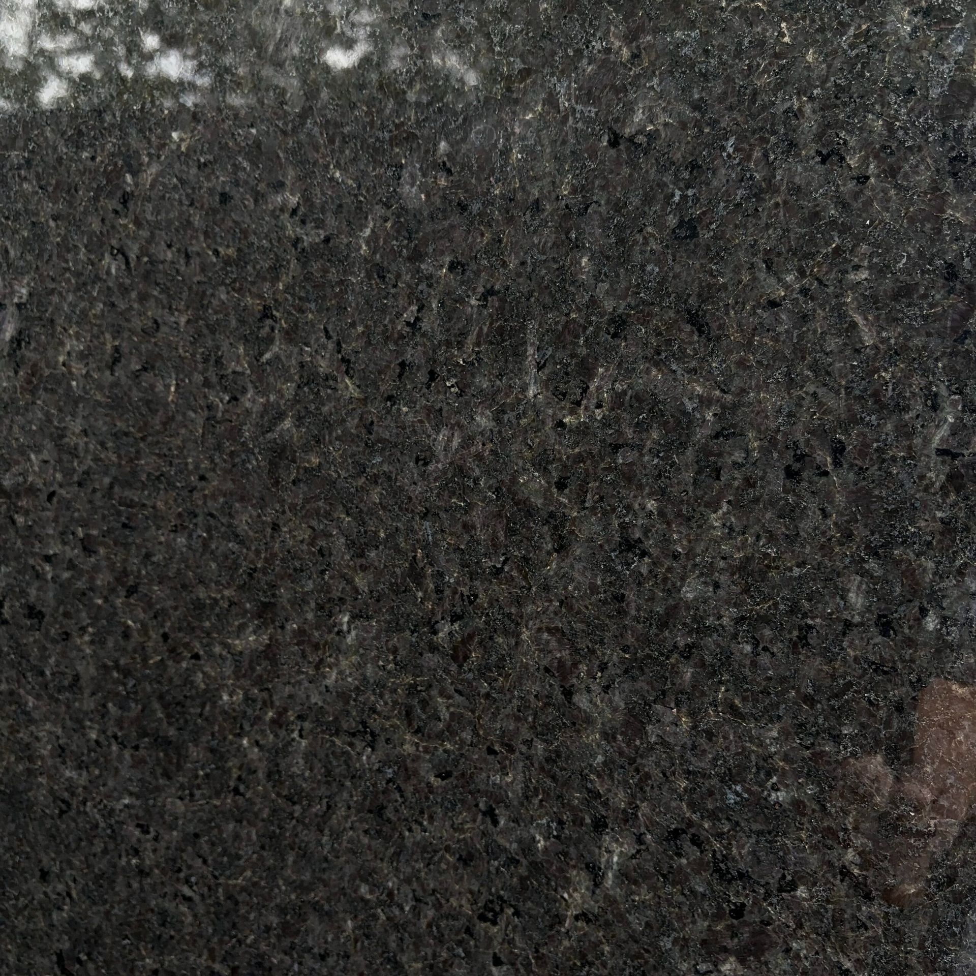 A close up of a black granite counter top
