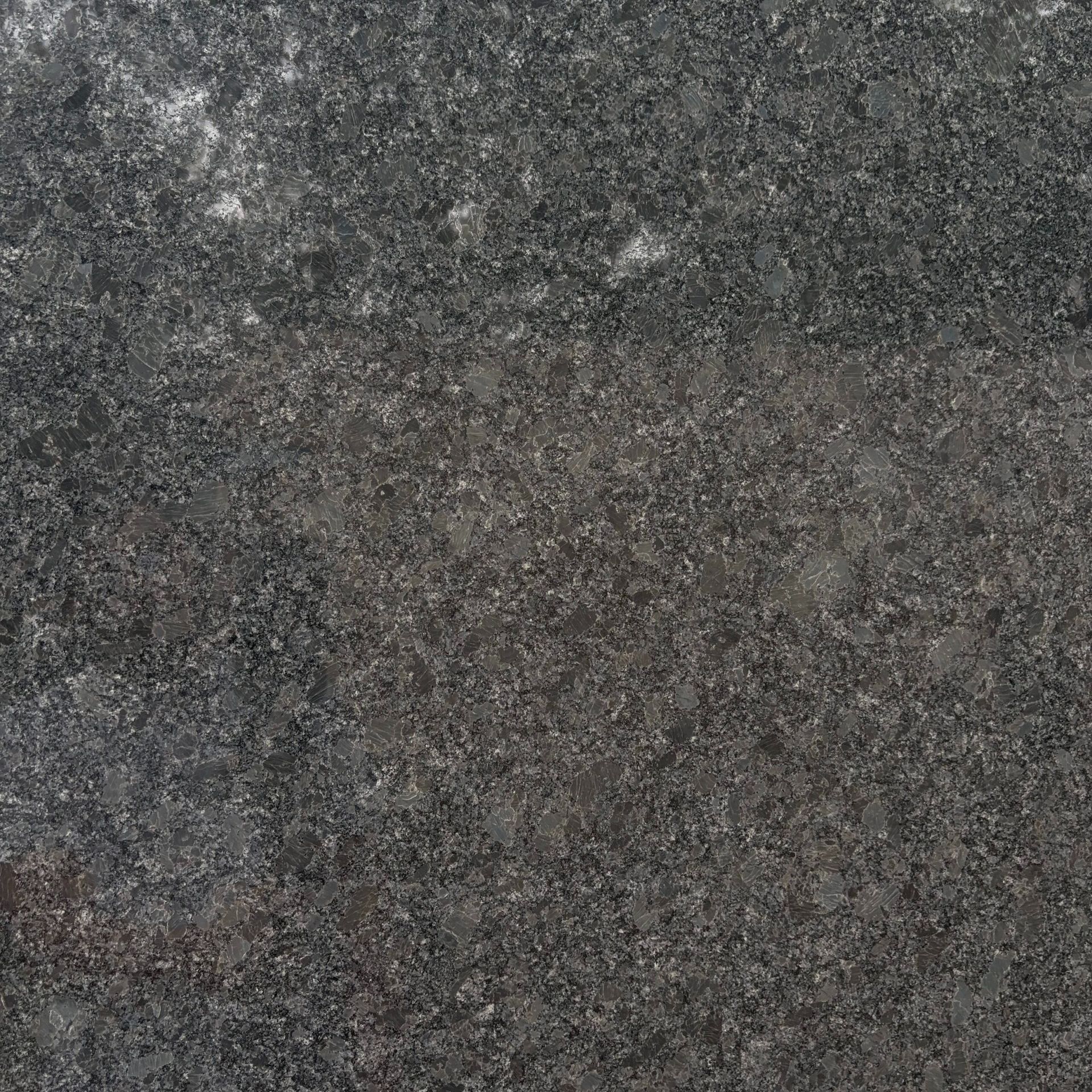A close up of a black granite counter top.