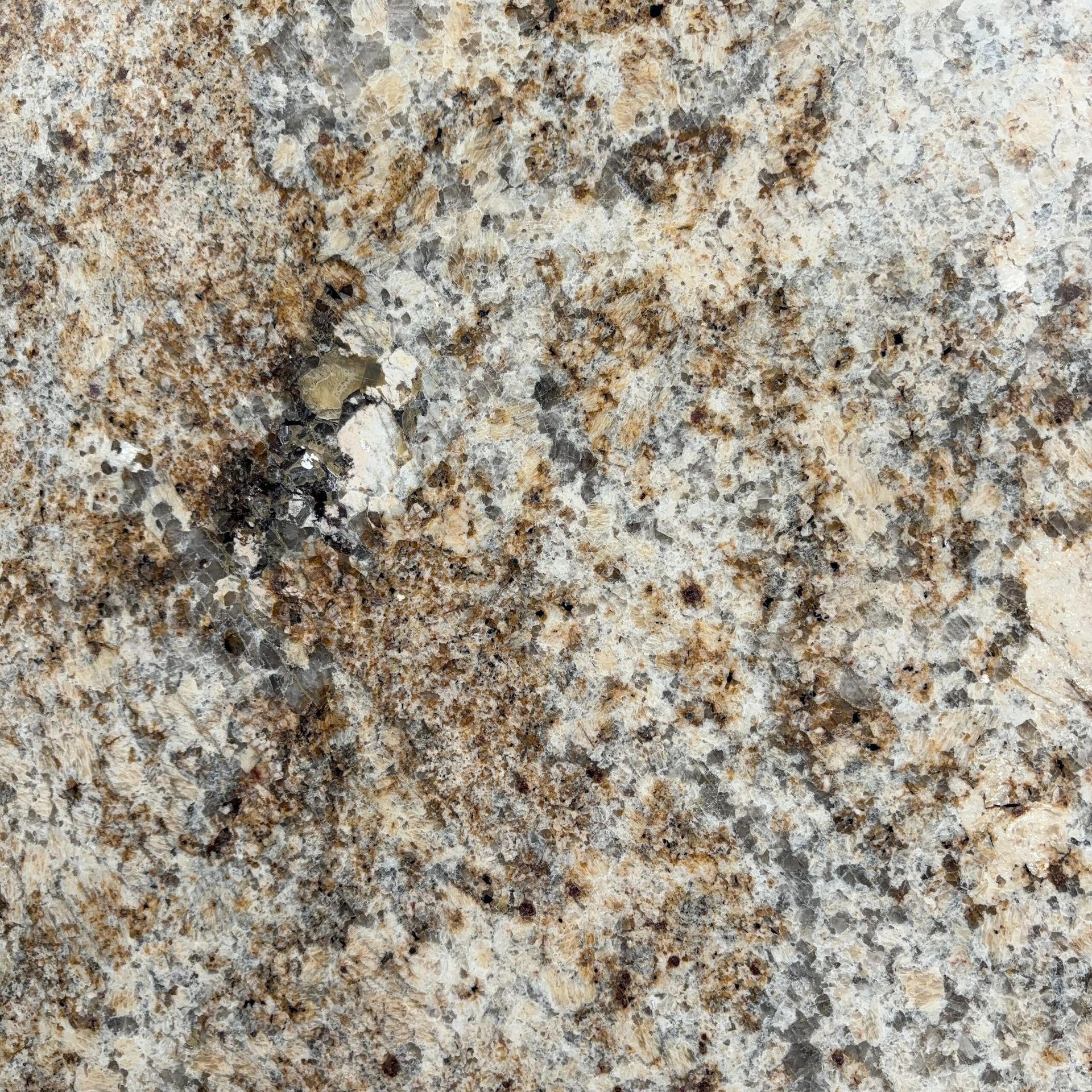 A close up of a brown and white granite counter top