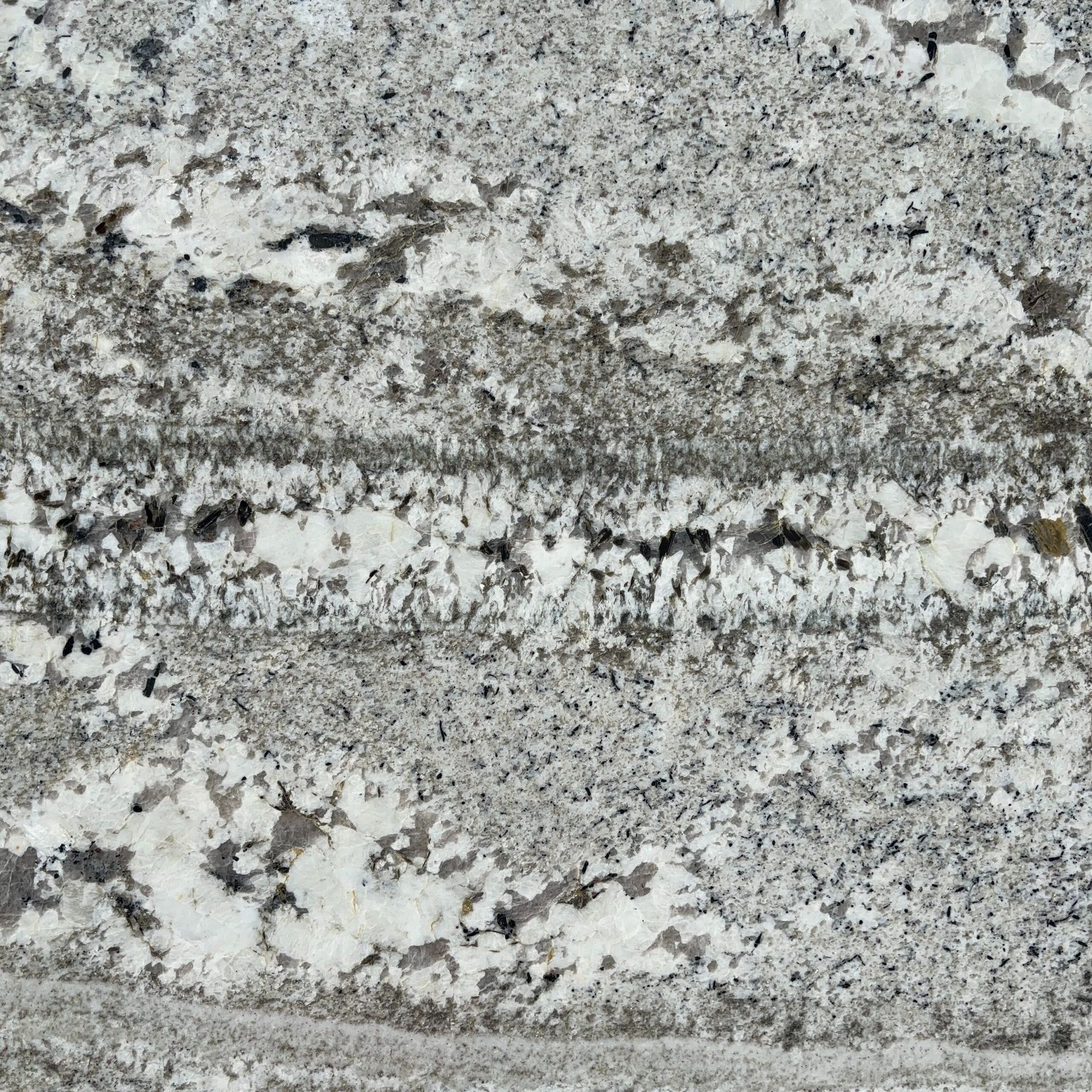 A close up of a granite counter top with a gray and white marble texture.