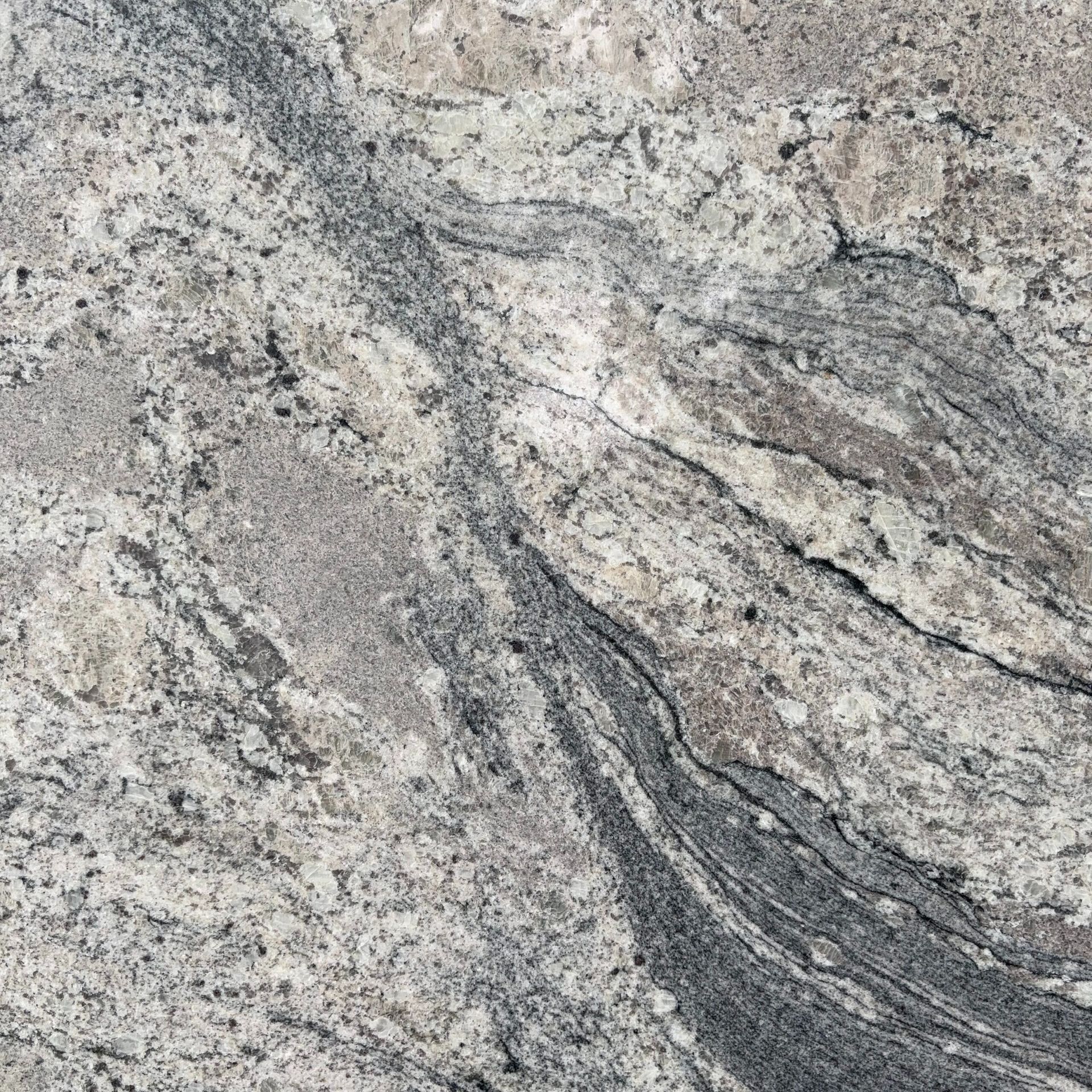 A close up of a granite counter top with a swirl pattern.