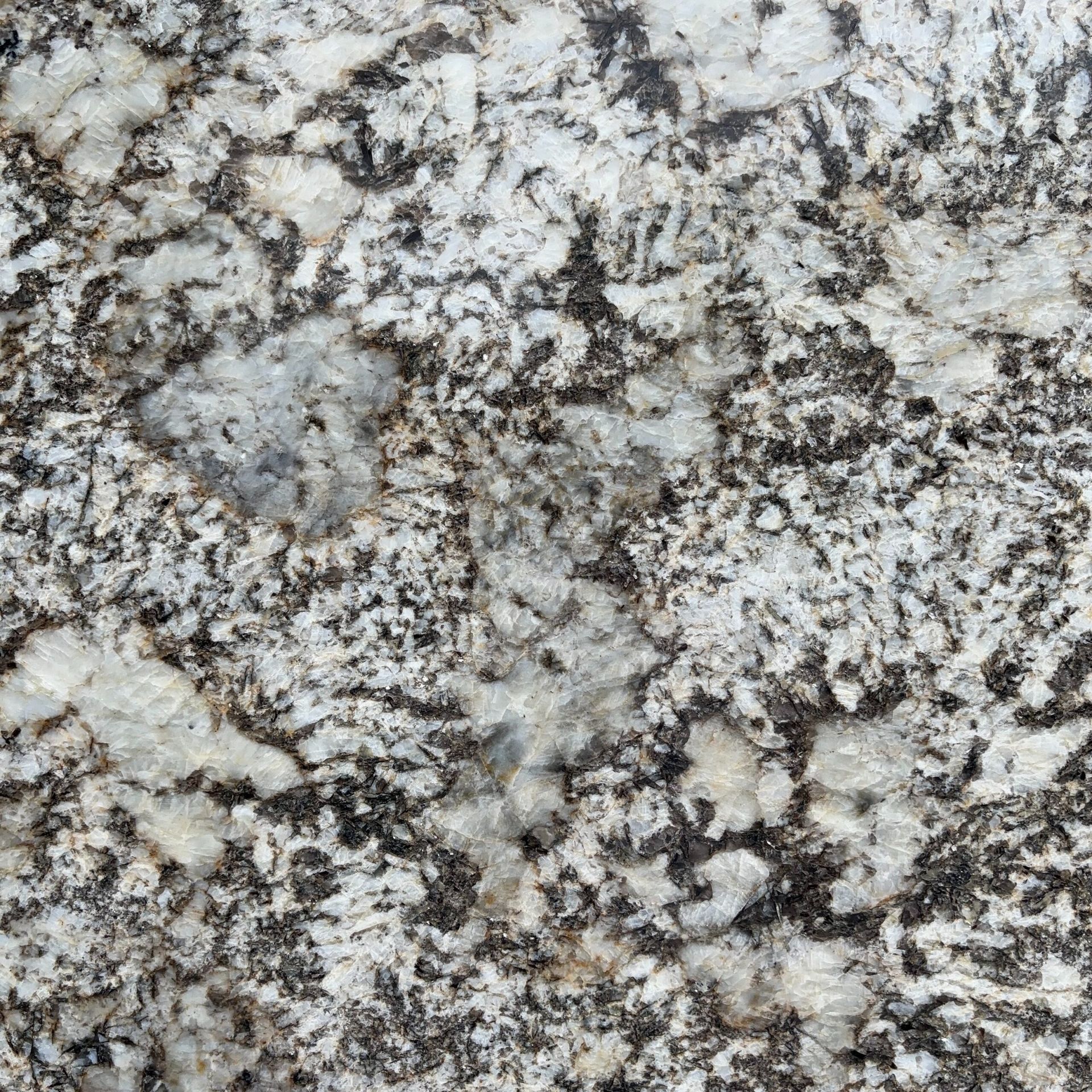 A close up of a granite counter top with black and white spots.