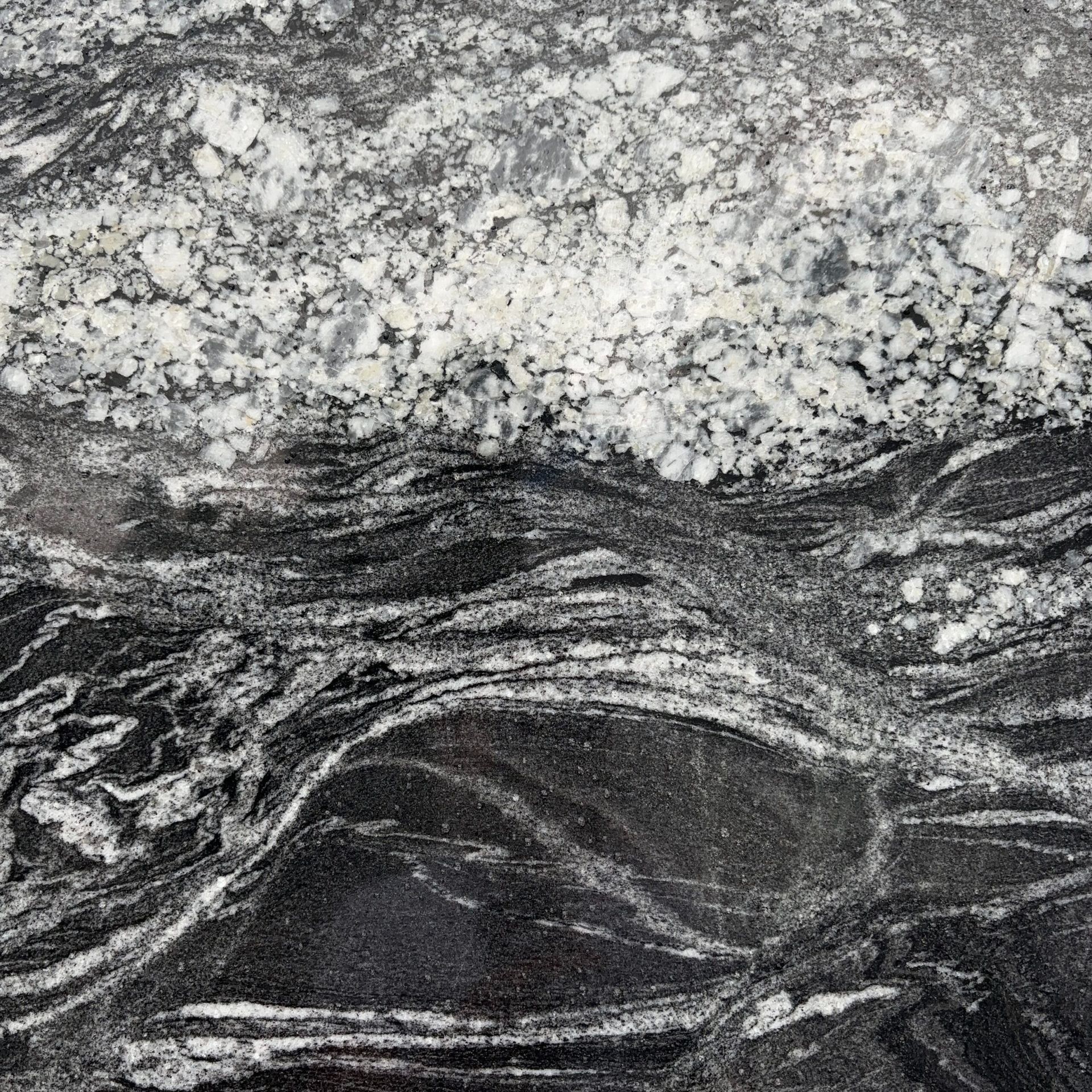 A close up of a black and white granite counter top.