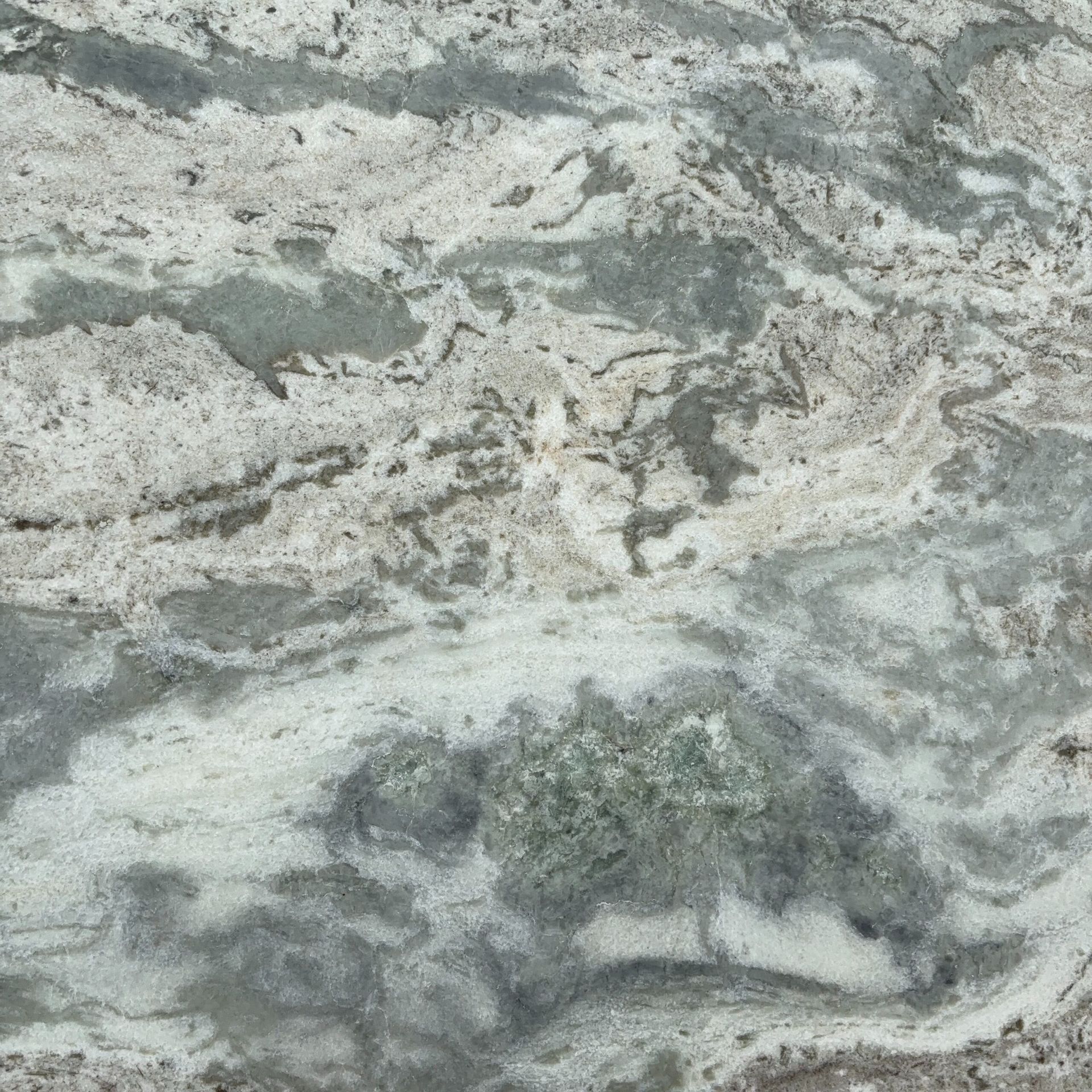 A close up of a granite counter top with a marble texture