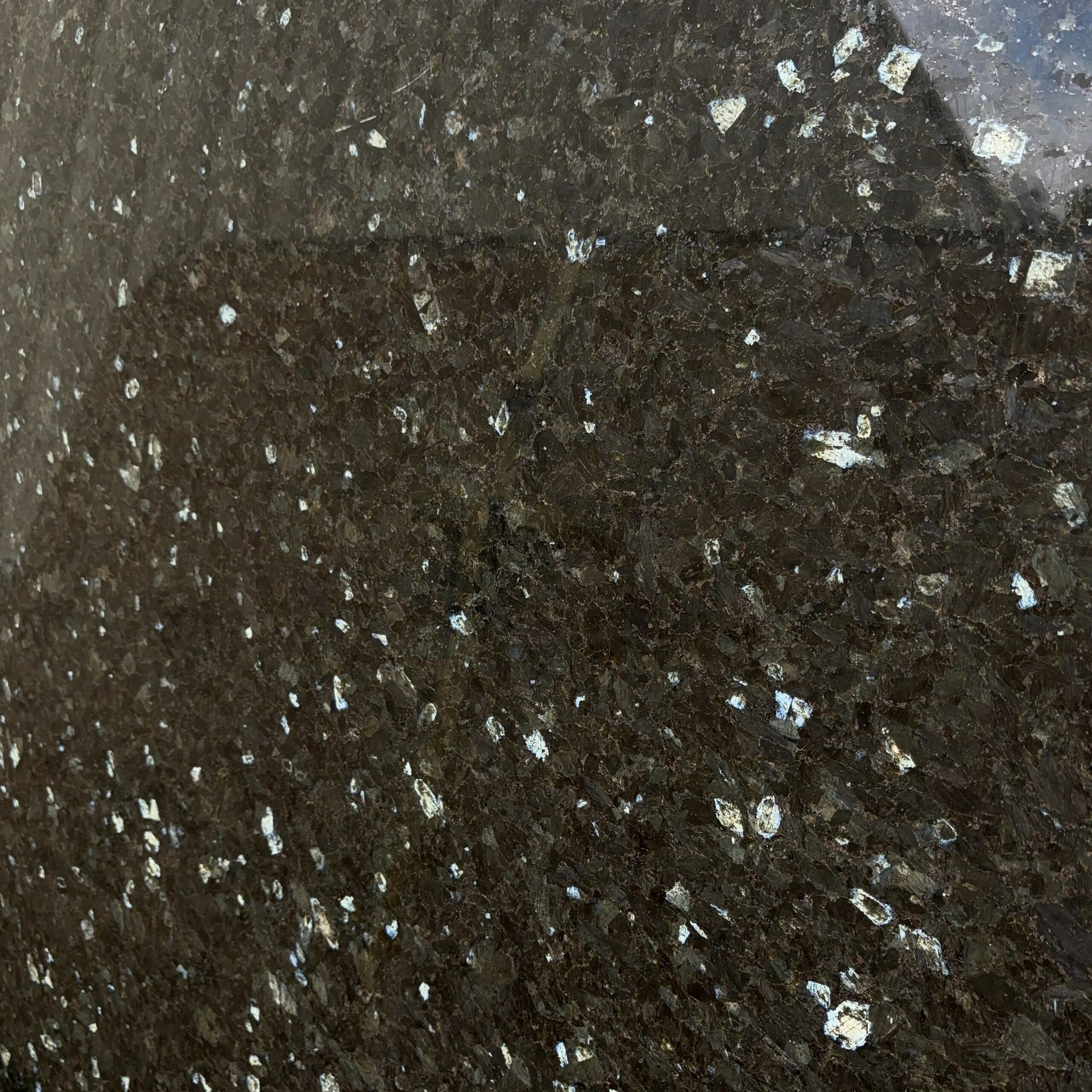 A close up of a black granite counter top
