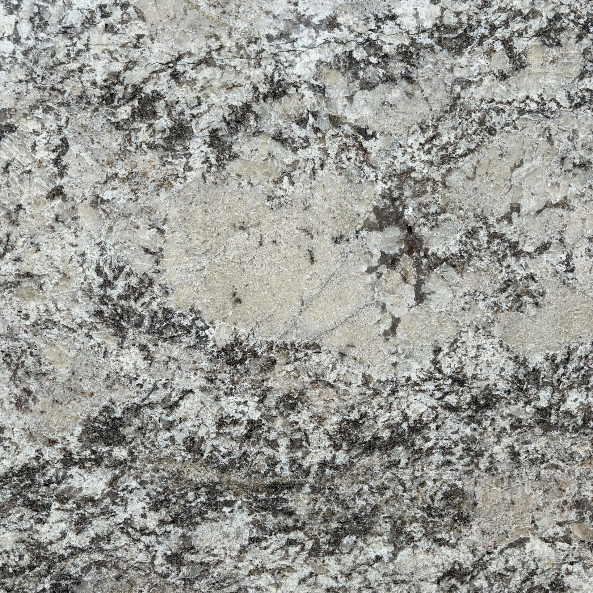 A close up of a white granite counter top.