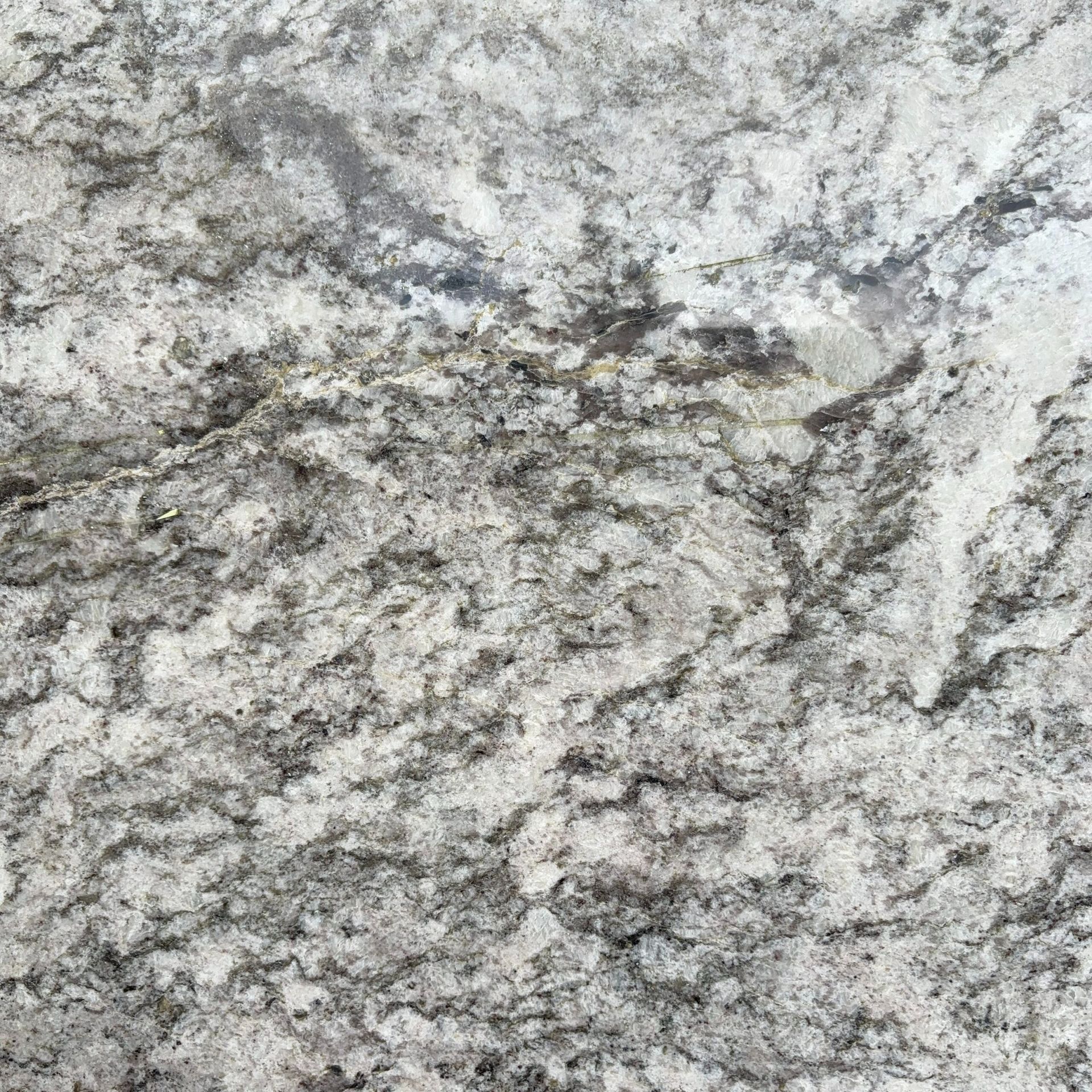 A close up of a white granite counter top.