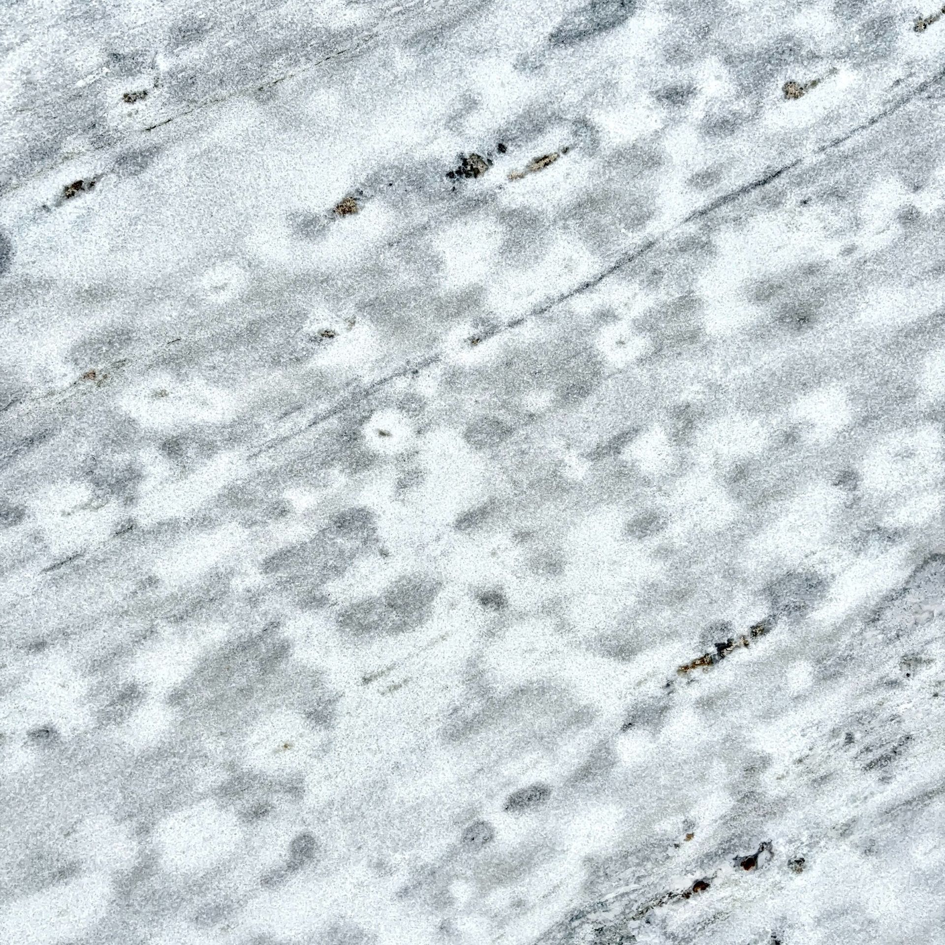 A close up of a gray and white marble texture.
