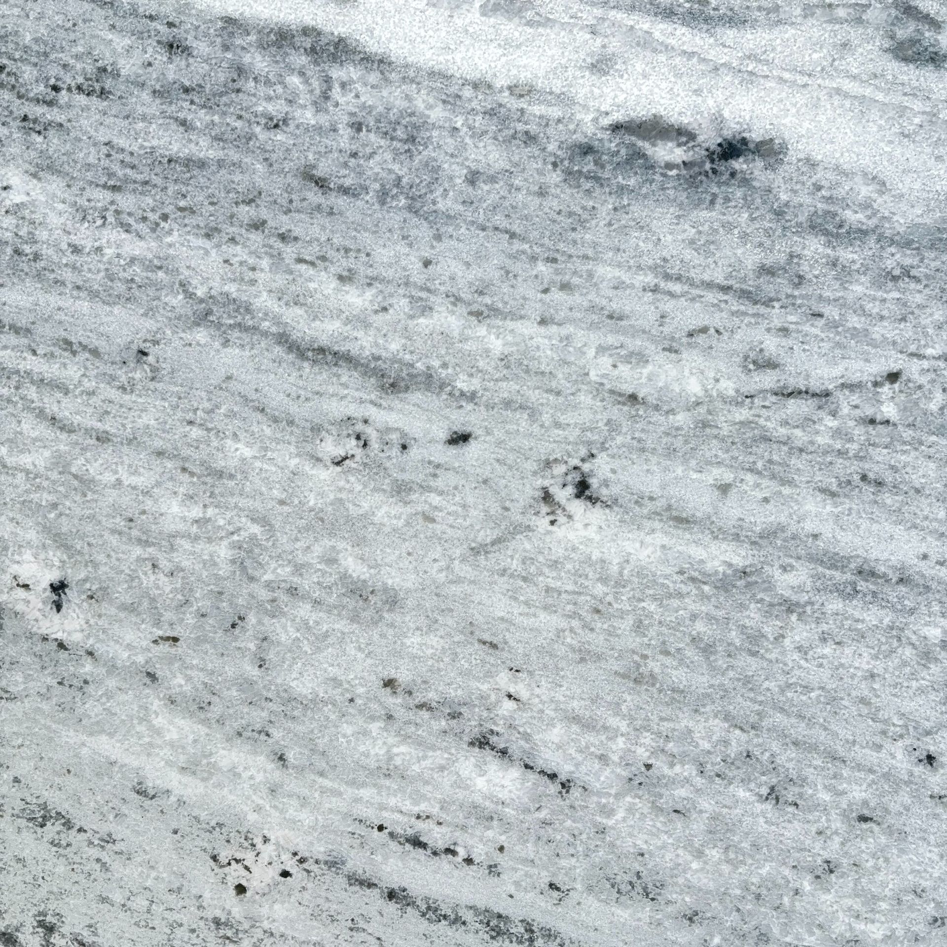 A close up of a white granite counter top.