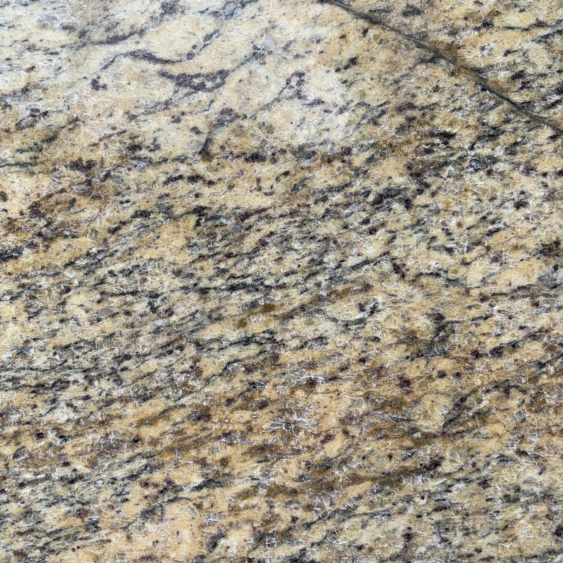 A close up of a yellow granite counter top