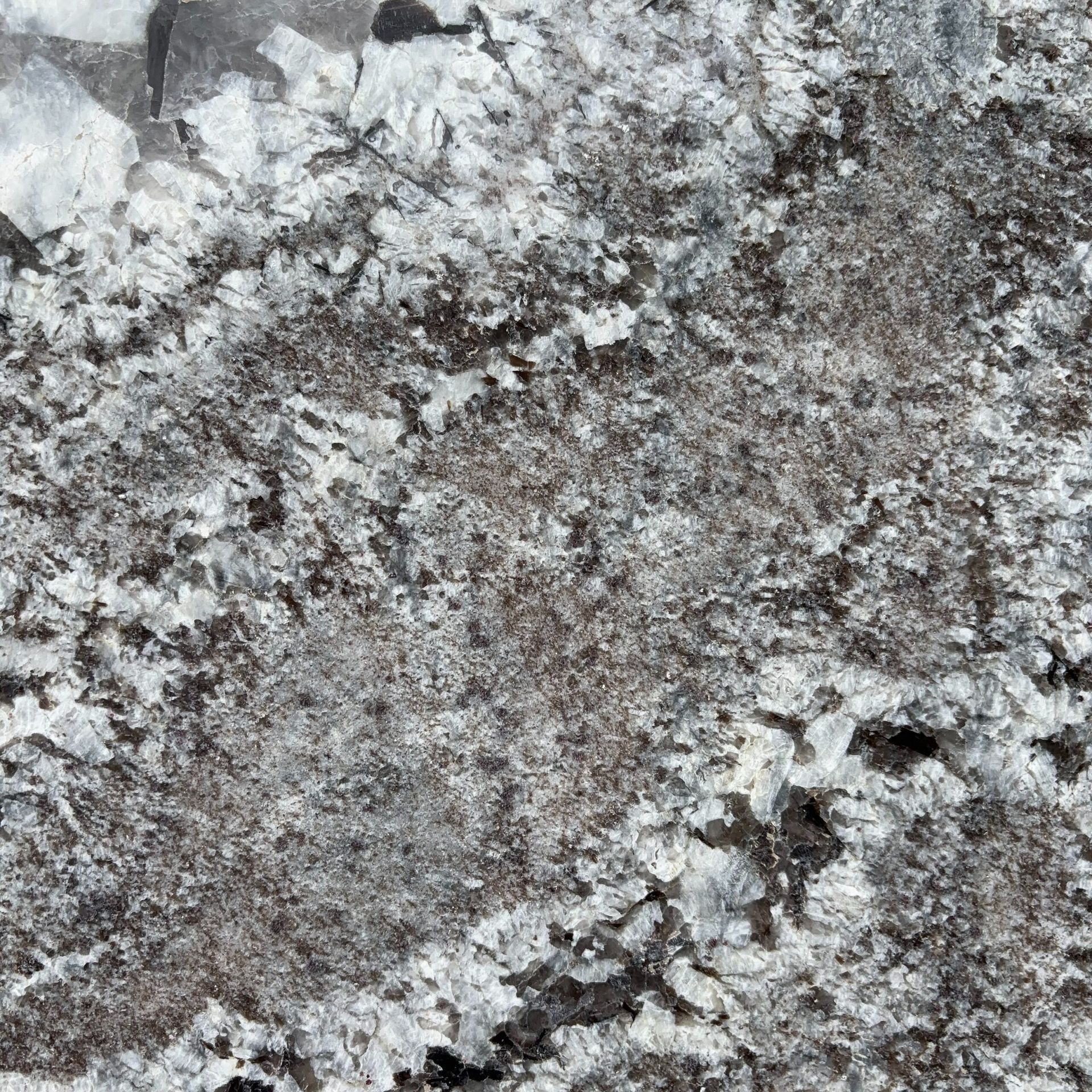 A close up of a granite counter top with a lot of white spots