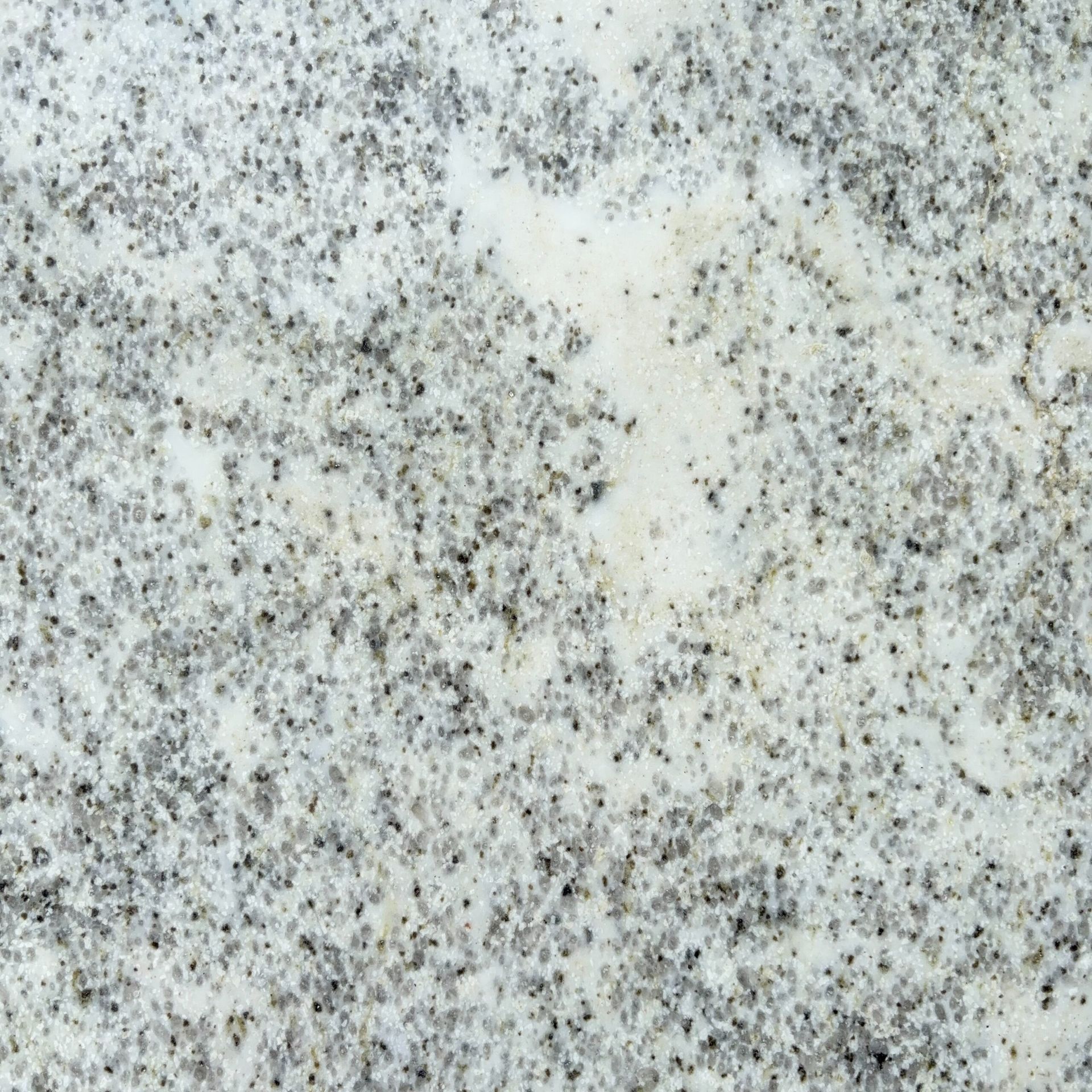 A close up of a white and gray granite counter top.
