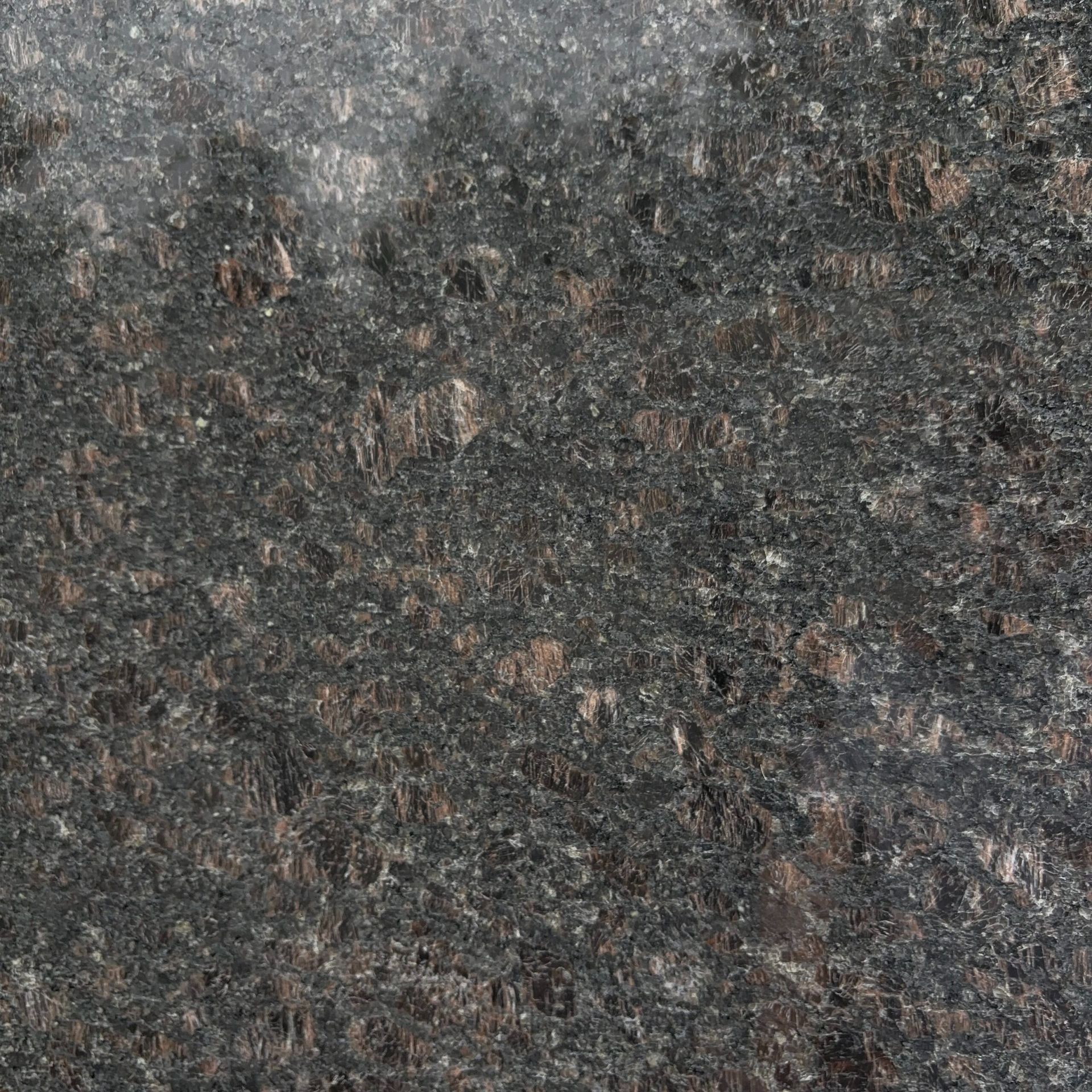 A close up of a black granite counter top