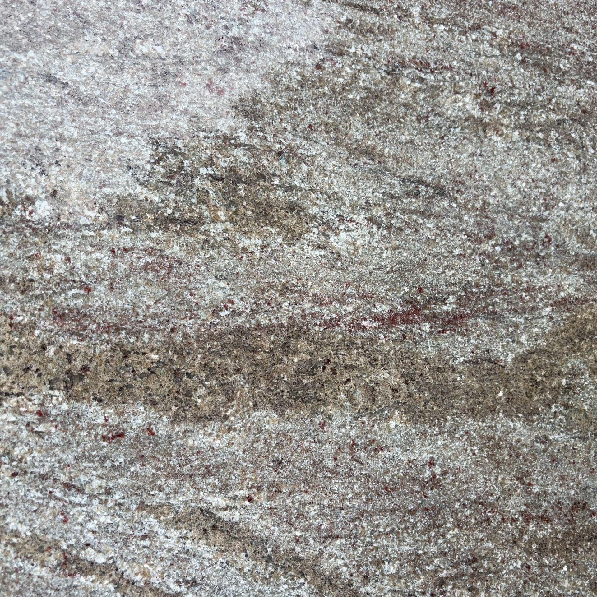 A close up of a brown granite counter top.