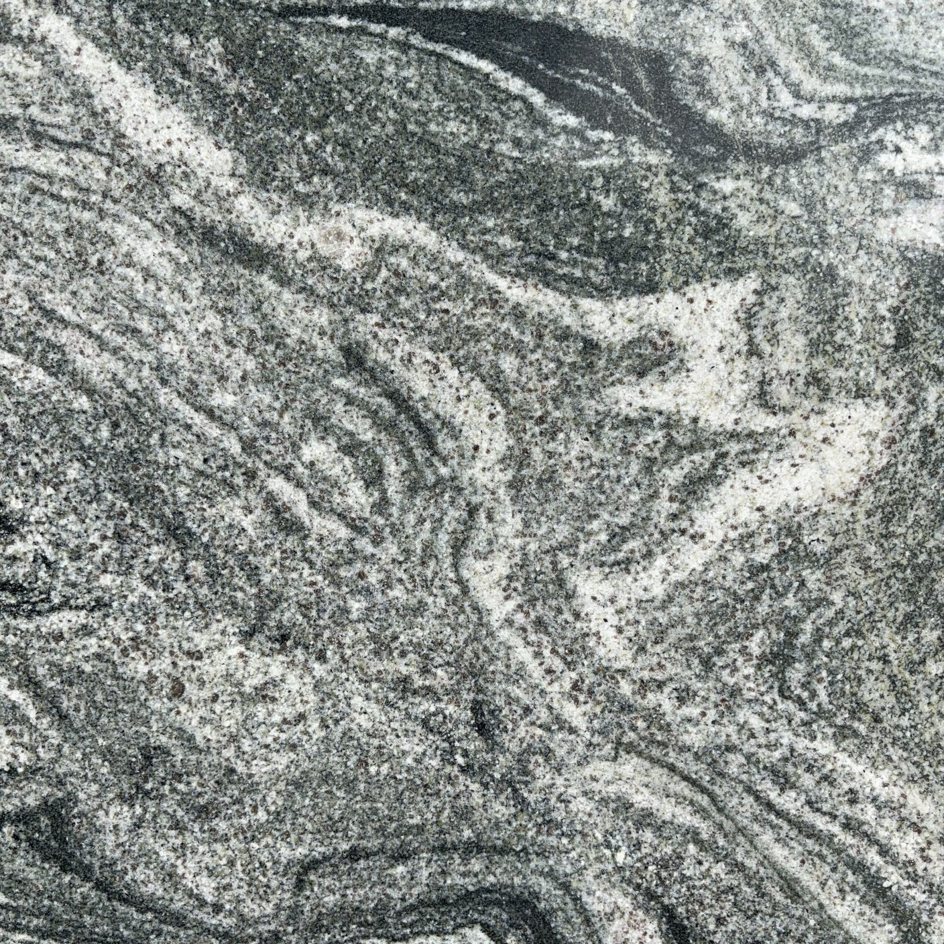 A close up of a granite counter top with a marble texture.