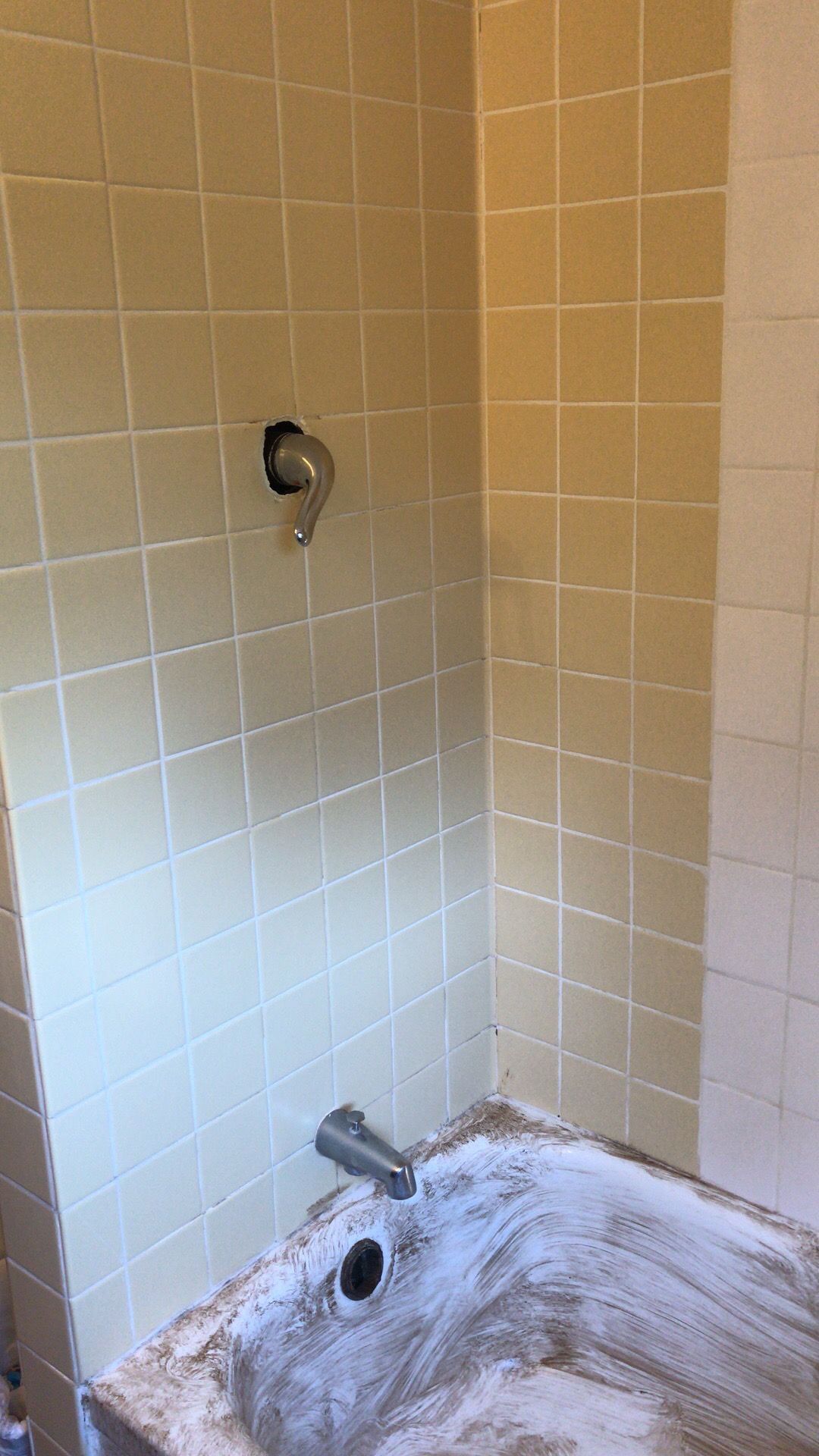A bathtub is sitting in a bathroom next to a shower