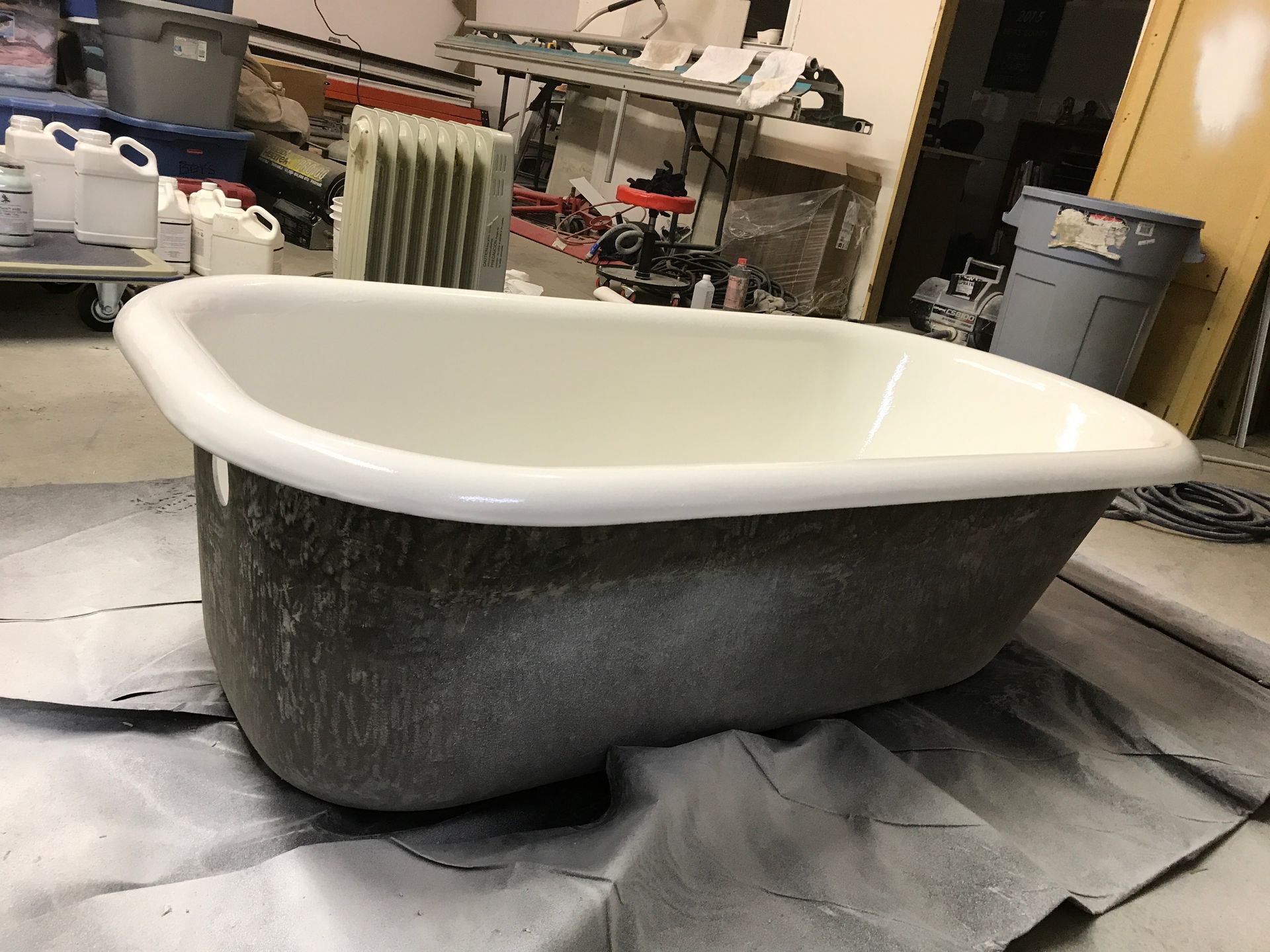 A bathtub is sitting on a table in a room