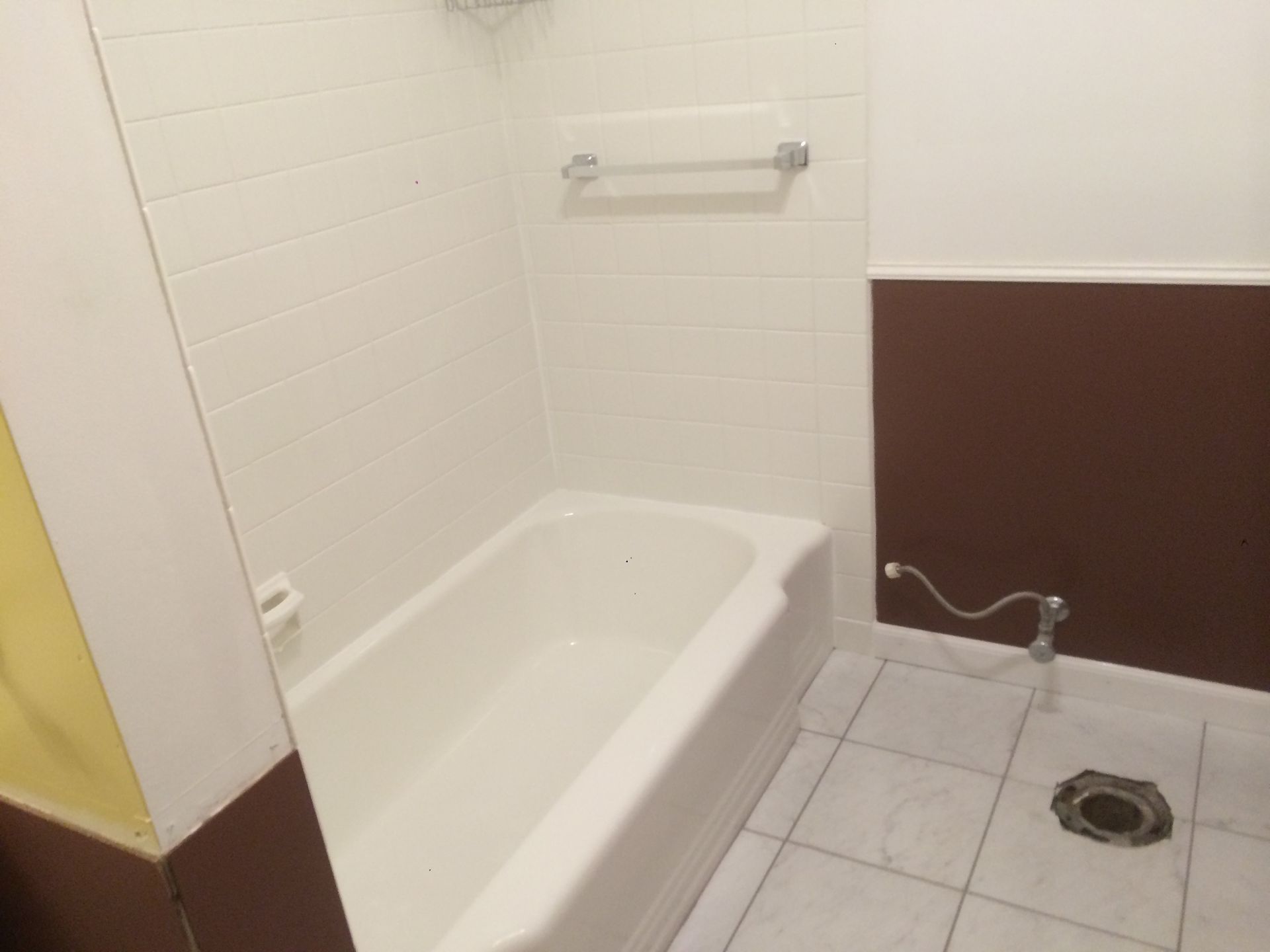 A bathroom with a bathtub and a toilet