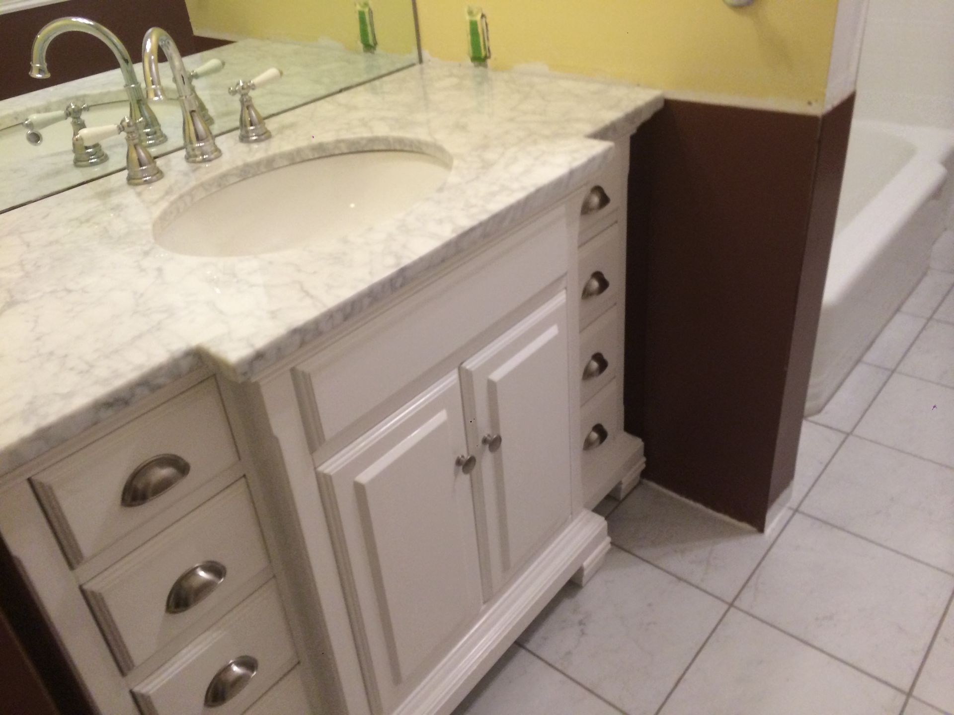 A bathroom vanity with a sink and a mirror