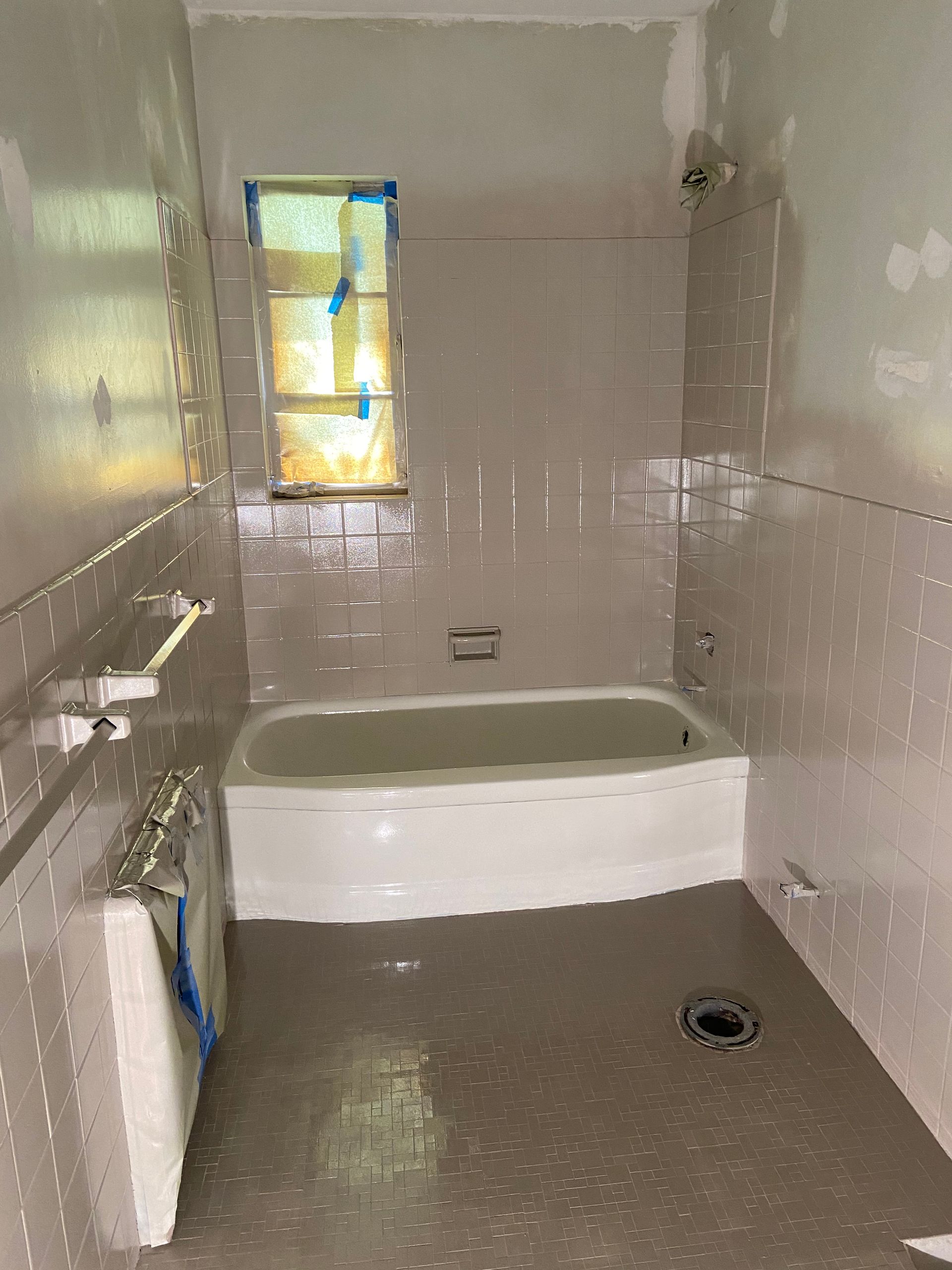 An empty bathroom with a bathtub and a window