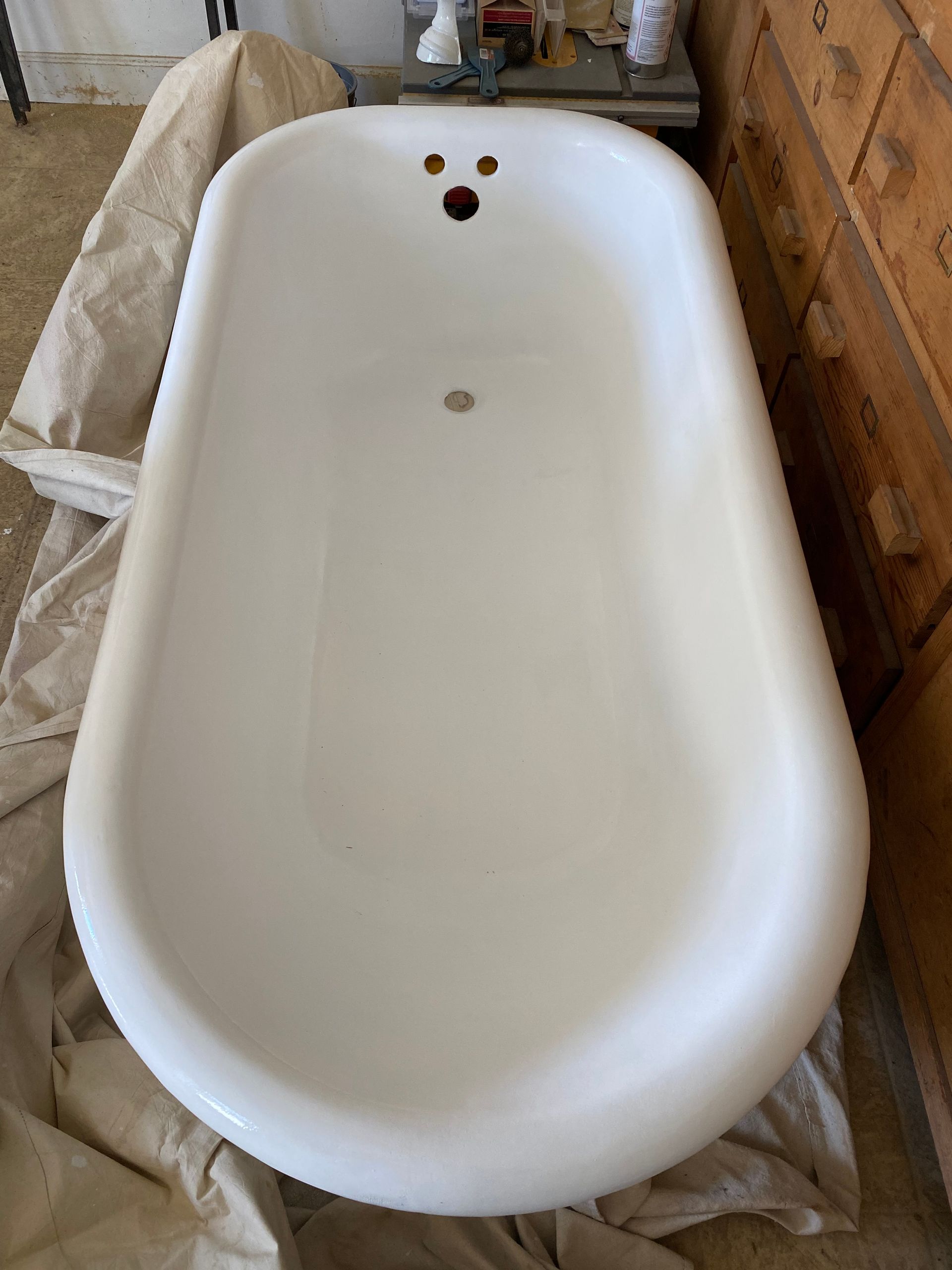 A white bathtub is sitting on the floor