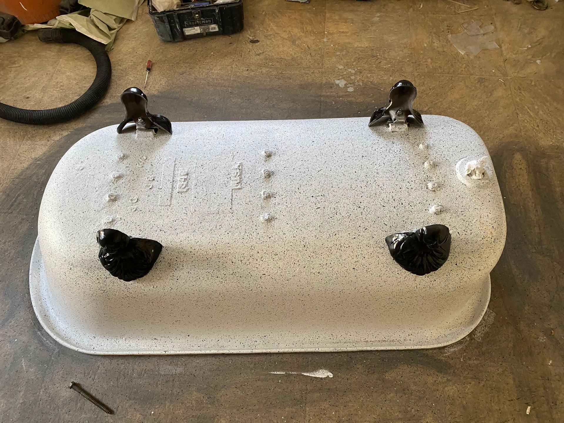 A white bathtub with black feet is sitting on the floor