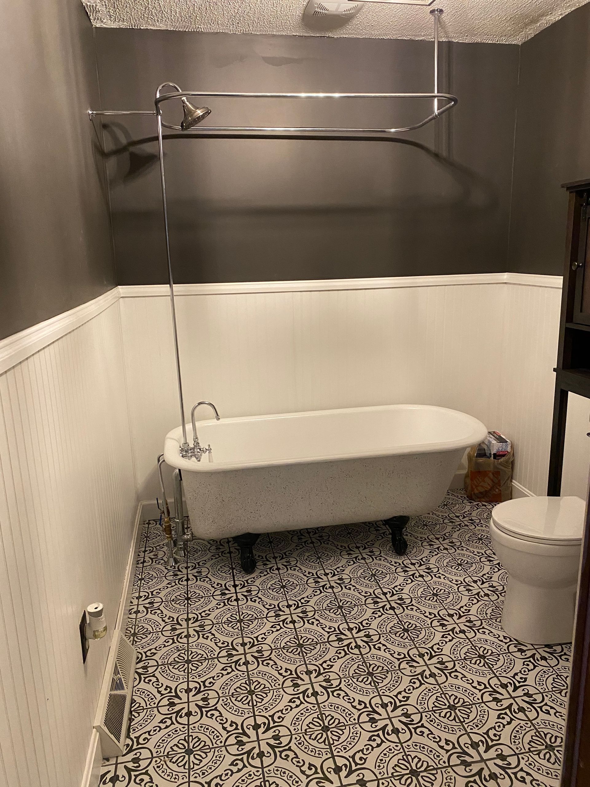 A bathroom with a bathtub, toilet and shower