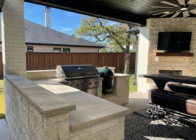 There is a grill and a television on the patio.