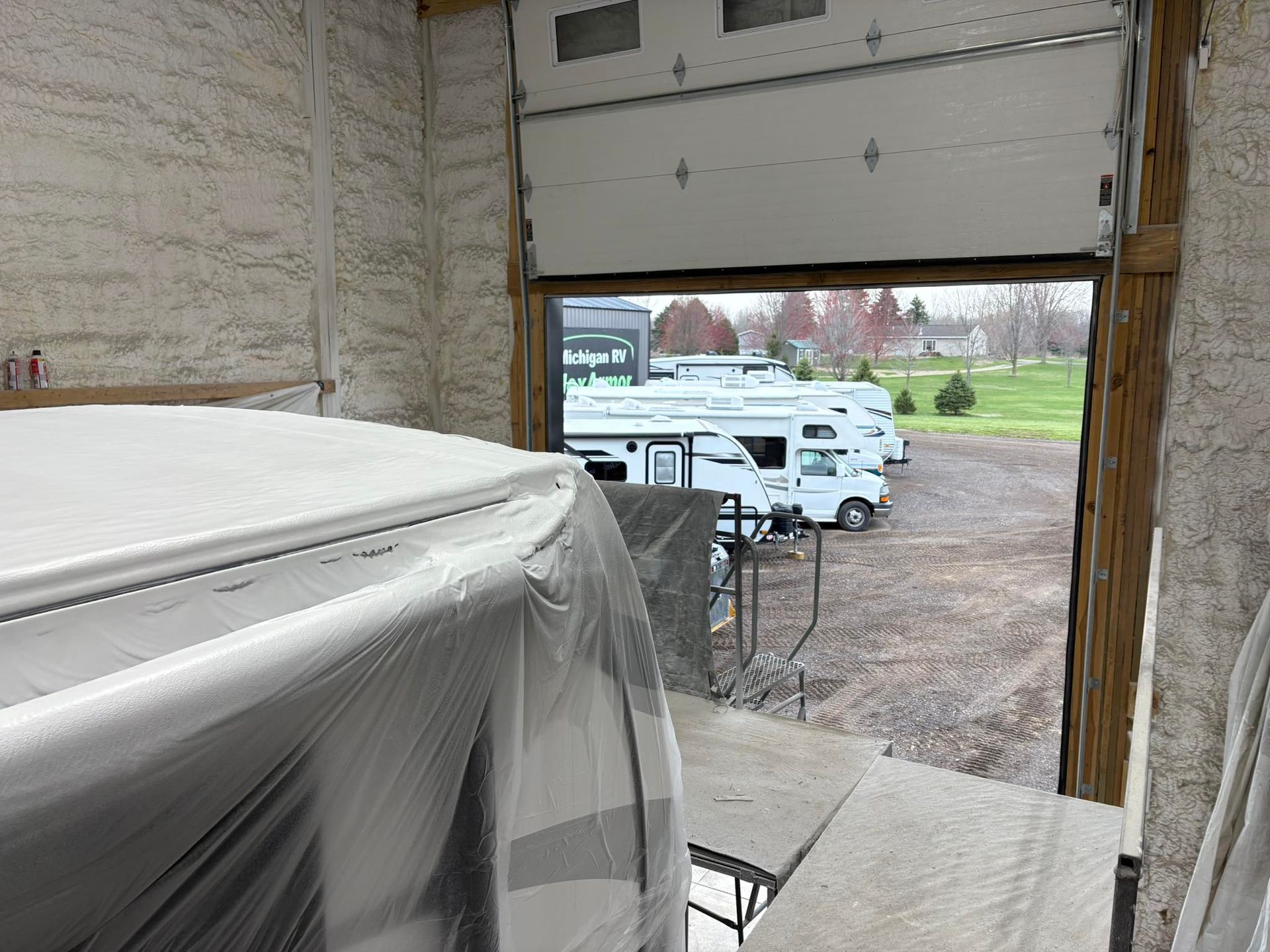 A garage door is open to a rv park.