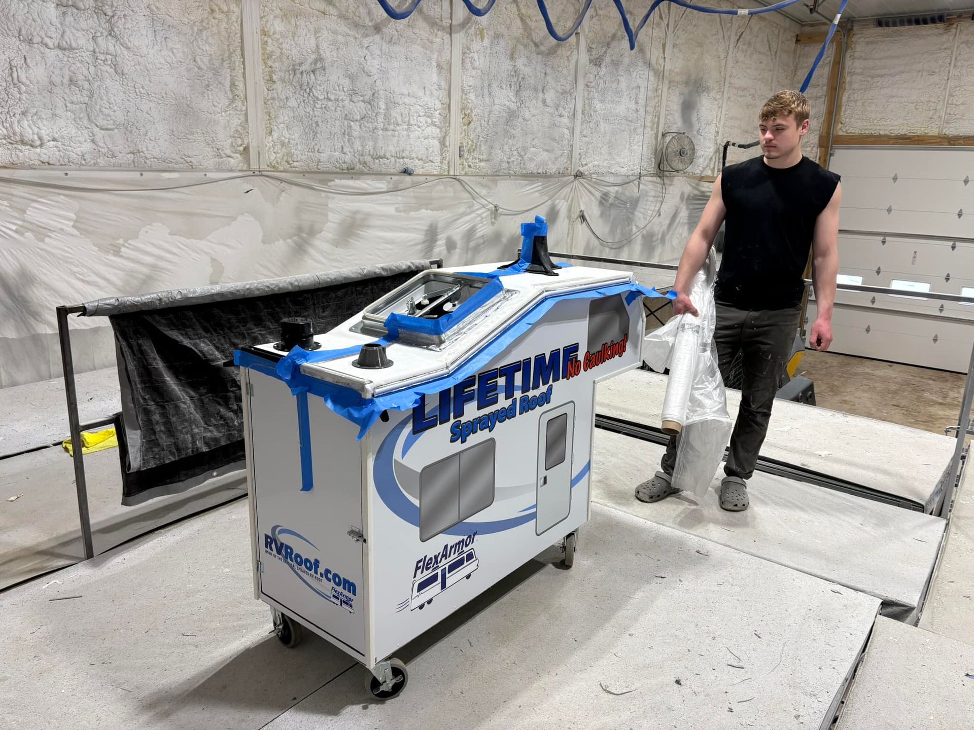 A man is standing next to a box that says lifetime on it.