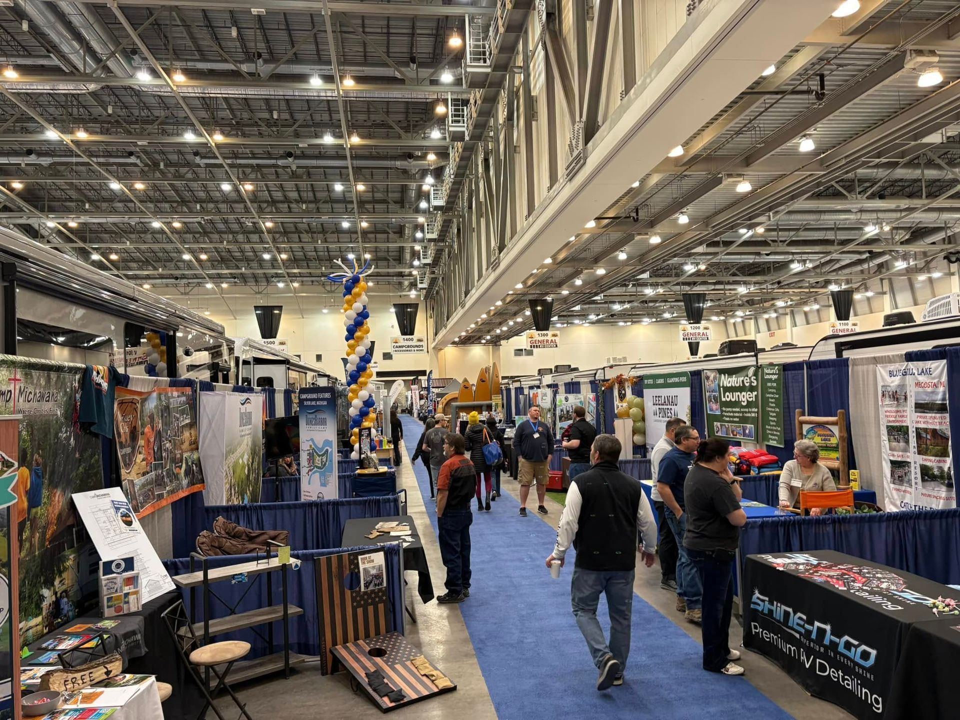 A group of people are walking through a convention hall.