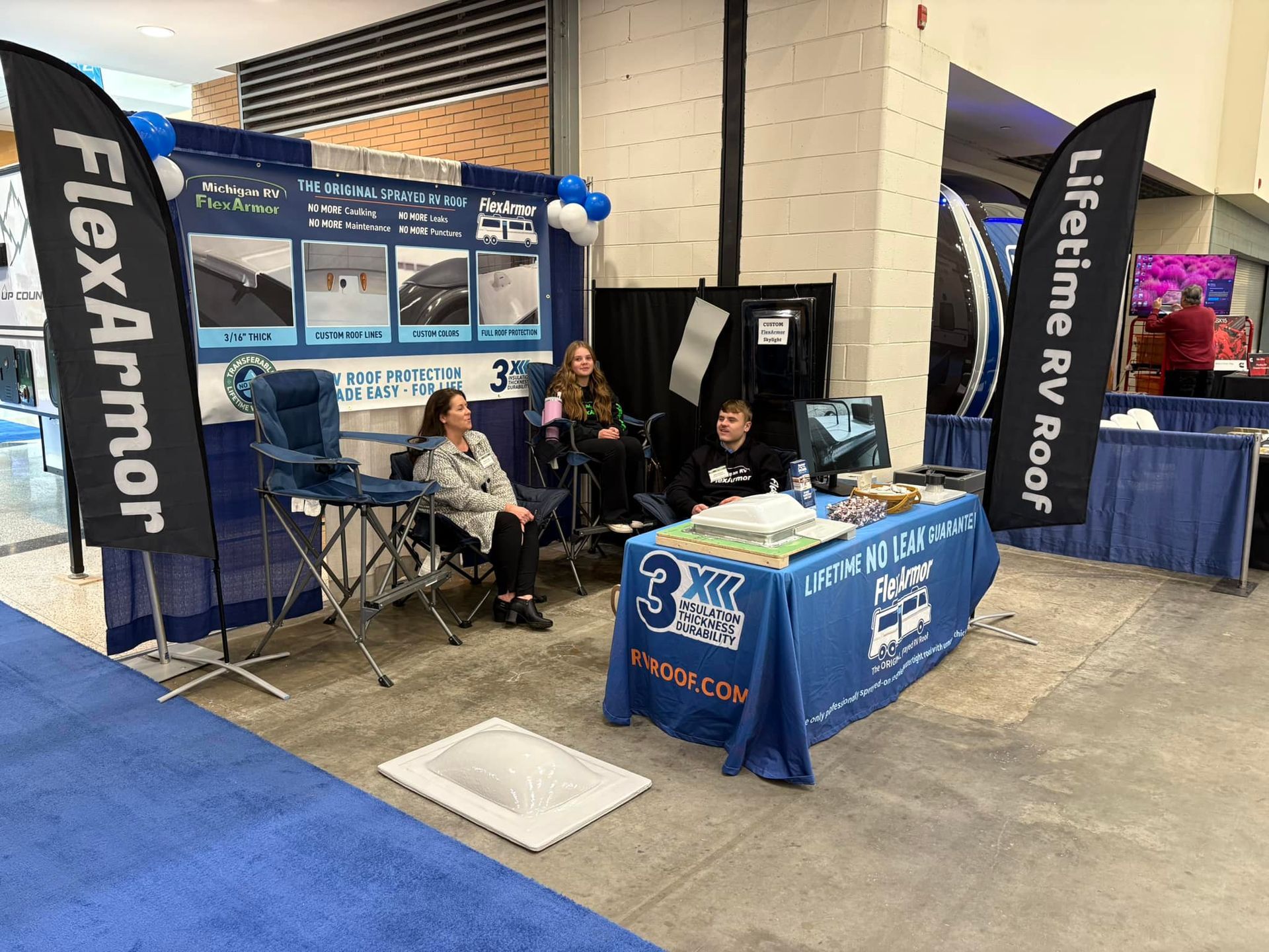 A group of people are sitting around a table at a convention.