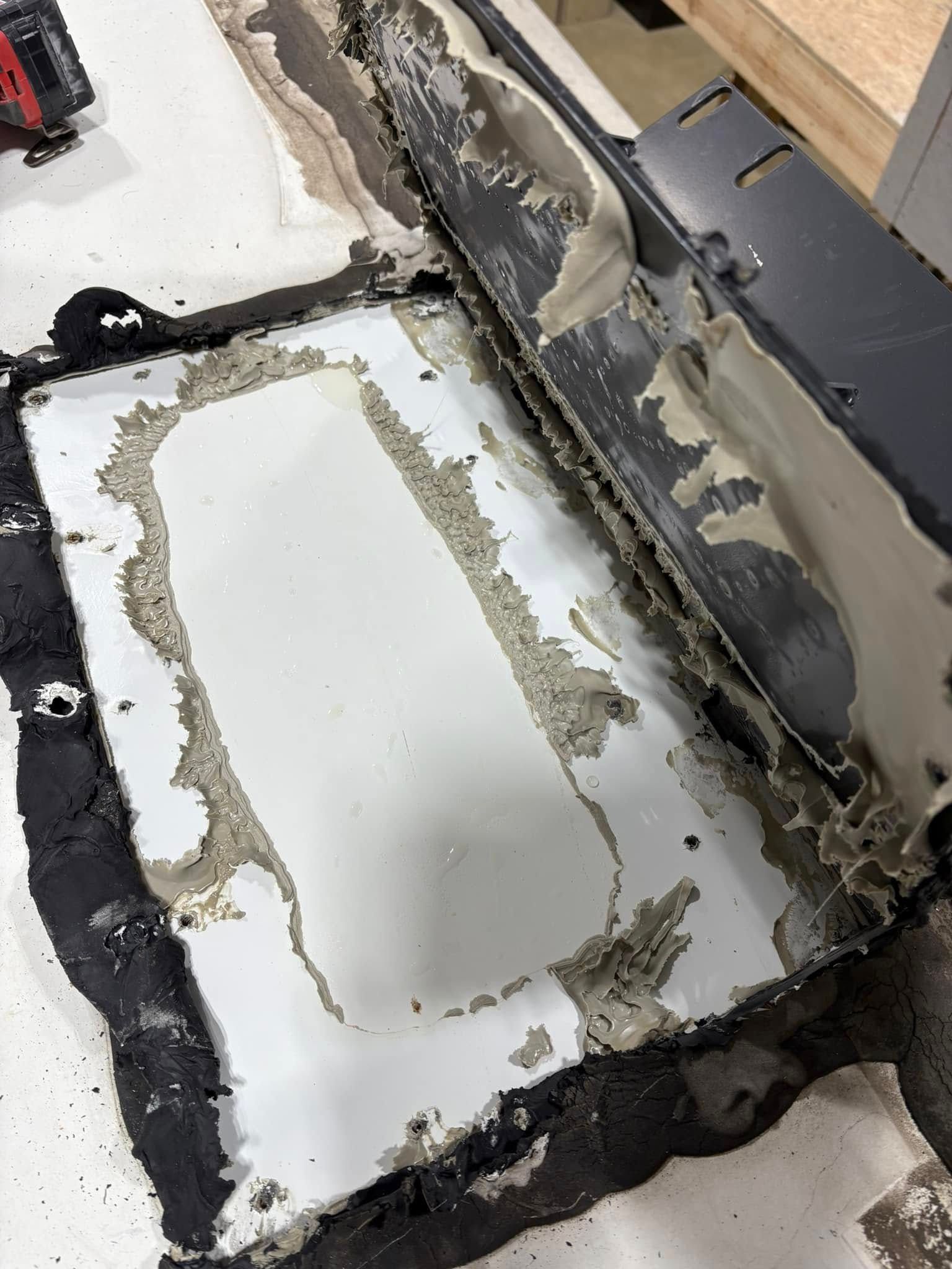 A piece of concrete is sitting on top of a white surface.