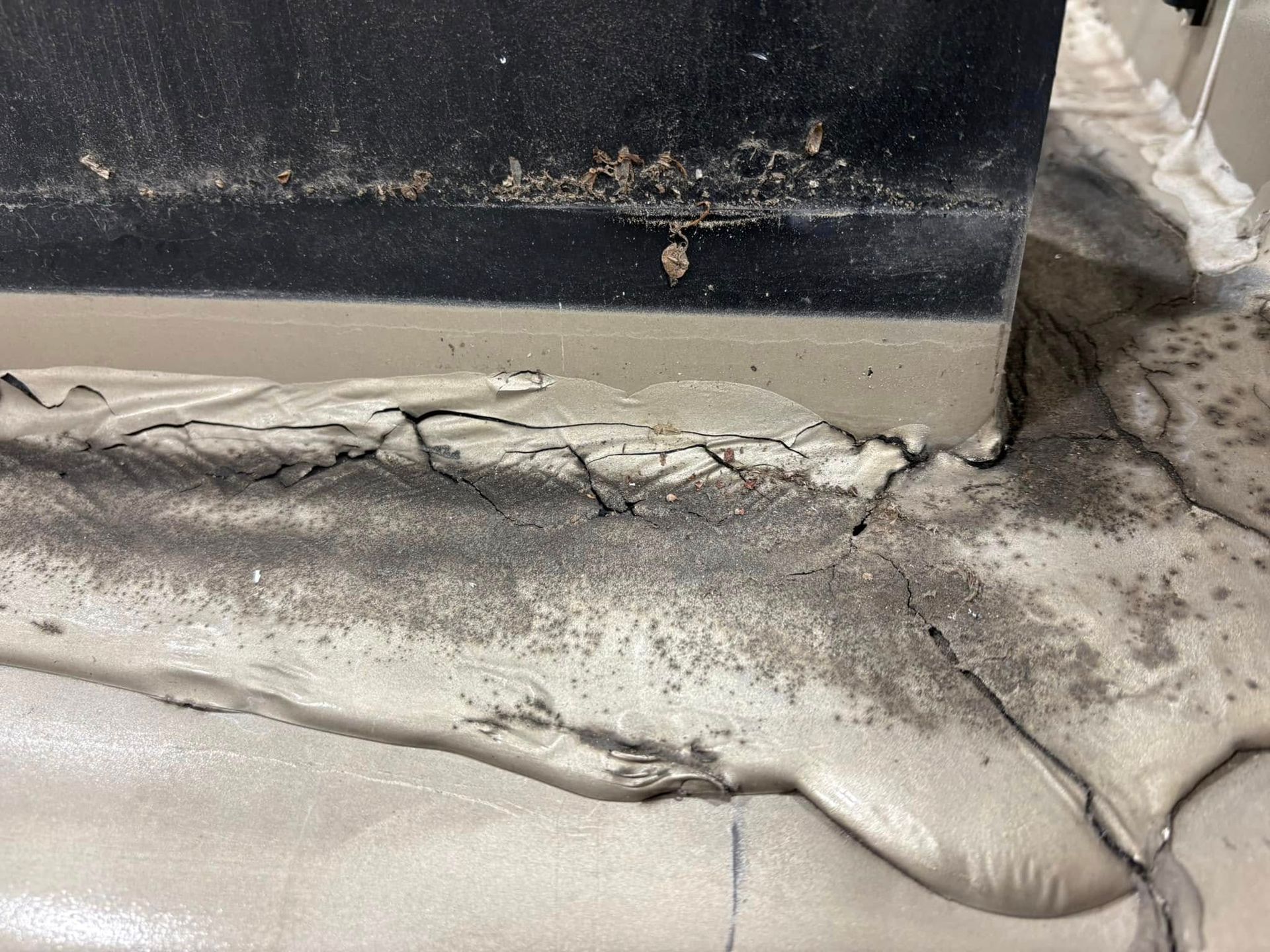 A close up of a concrete wall with a lot of concrete coming out of it.