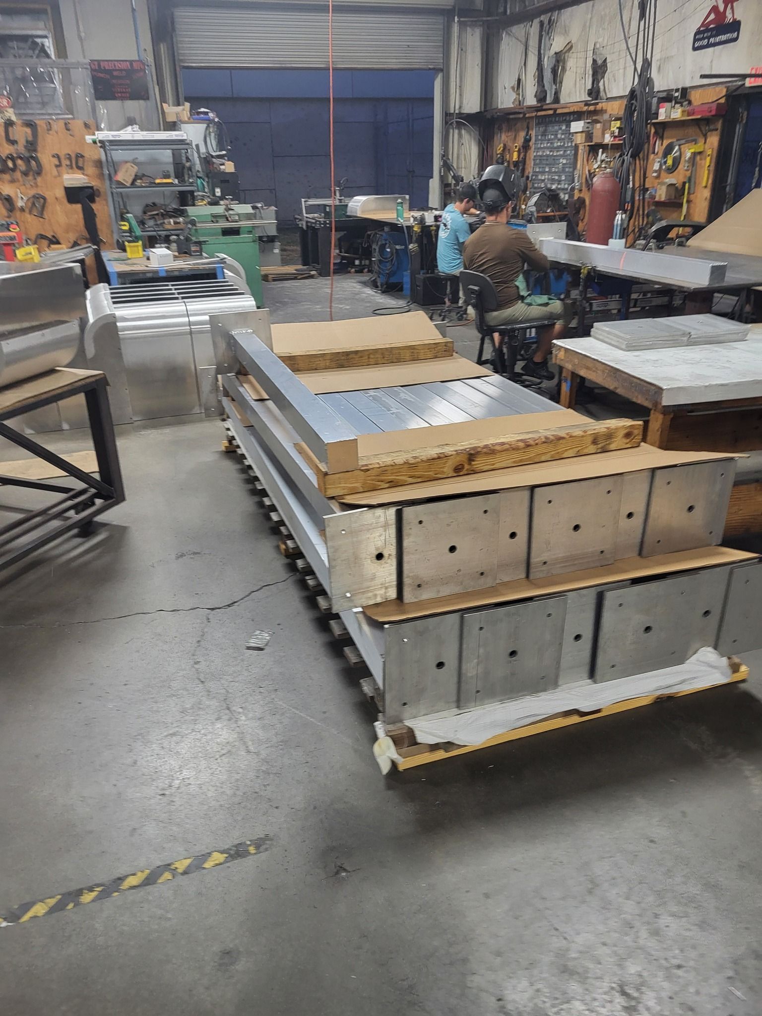 Stack of metal fabrication components in a workshop.