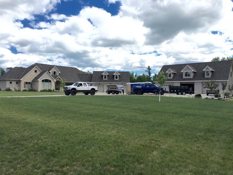 A row of houses with trucks parked in front of them
