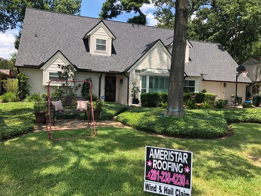 House with newly installed gray roof and Ameristar Roofing sign in front yard.