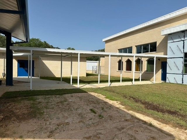 There is a covered walkway between two buildings.