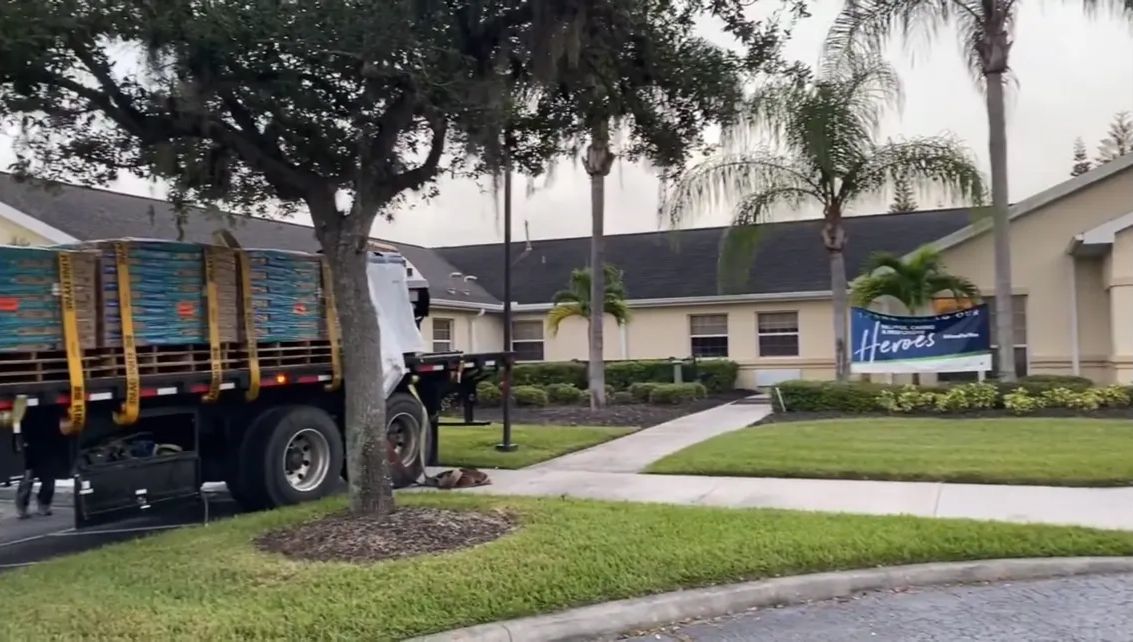 A garbage truck is parked in front of a house.